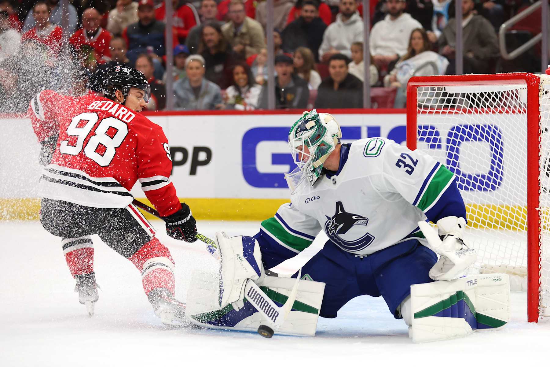 CHICAGO, ILLINOIS - OCTOBER 22: Kevin Lankinen #32 of the Vancouver Canucks makes a save against Connor Bedard #98 of the Chicago Blackhawks during the second period at the United Center on October 22, 2024 in Chicago, Illinois. (Photo by Michael Reaves/Getty Images)