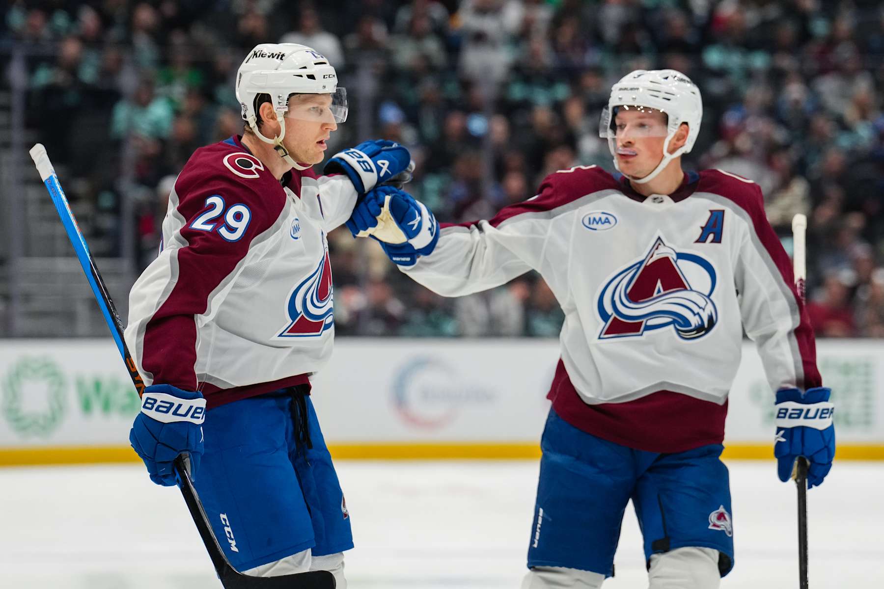 SEATTLE, WASHINGTON - OCTOBER 22: Nathan MacKinnon #29 celebrates with Cale Makar #8 of the Colorado Avalanche after scoring a goal during the second period of a game at Climate Pledge Arena on October 22, 2024 in Seattle, Washington. (Photo by Christopher Mast/NHLI via Getty Images)