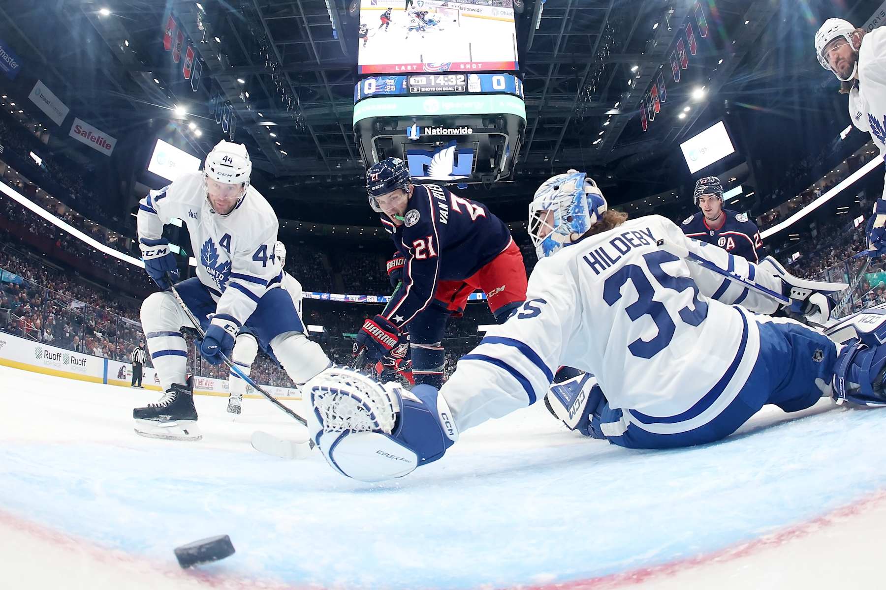 COLUMBUS, OHIO - OCTOBER 22:  James van Riemsdyk #21 of the Columbus Blue Jackets flips the puck past Morgan Rielly #44 of the Toronto Maple Leafs and Dennis Hildeby #35 for a goal during the first period of the game at Nationwide Arena on October 22, 2024 in Columbus, Ohio. Columbus defeated Toronto 6-2. (Photo by Kirk Irwin/NHLI via Getty Images)