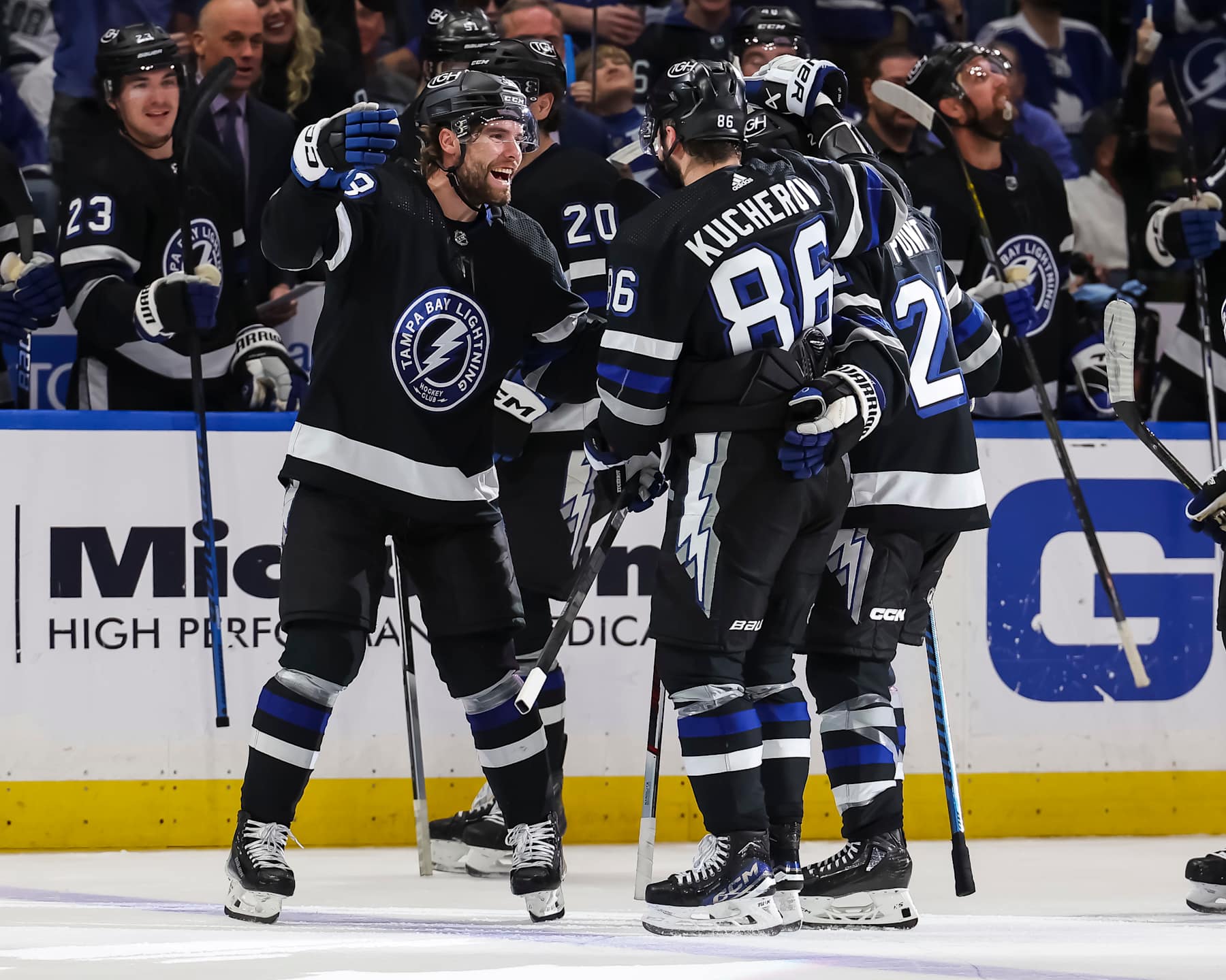 TAMPA, FL - APRIL 17: Nikita Kucherov #86 of the Tampa Bay Lightning celebrates his 100th assist on the season with Brandon Hagel #38 and Brayden Point #21 against the Toronto Maple Leafs during the second period at the Amalie Arena on April 17, 2024 in Tampa, Florida. (Photo by Mark LoMoglio/NHLI via Getty Images)