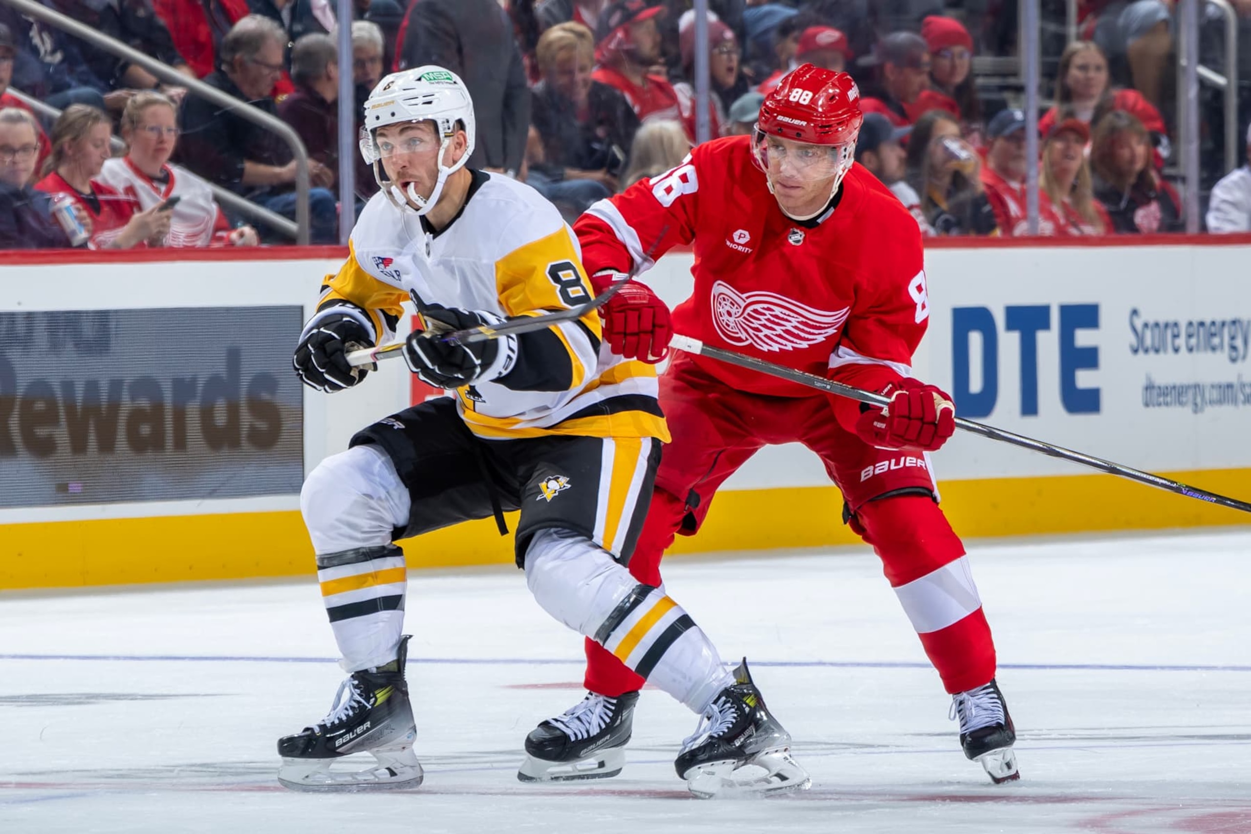 DETROIT, MICHIGAN - OCTOBER 10: Patrick Kane #88 of the Detroit Red Wings battles for position with Michael Bunting #8 of the Pittsburgh Penguins during the third period at Little Caesars Arena on October 10, 2024 in Detroit, Michigan. Pittsburgh defeated Detroit 6-3. (Photo by Dave Reginek/NHLI via Getty Images)