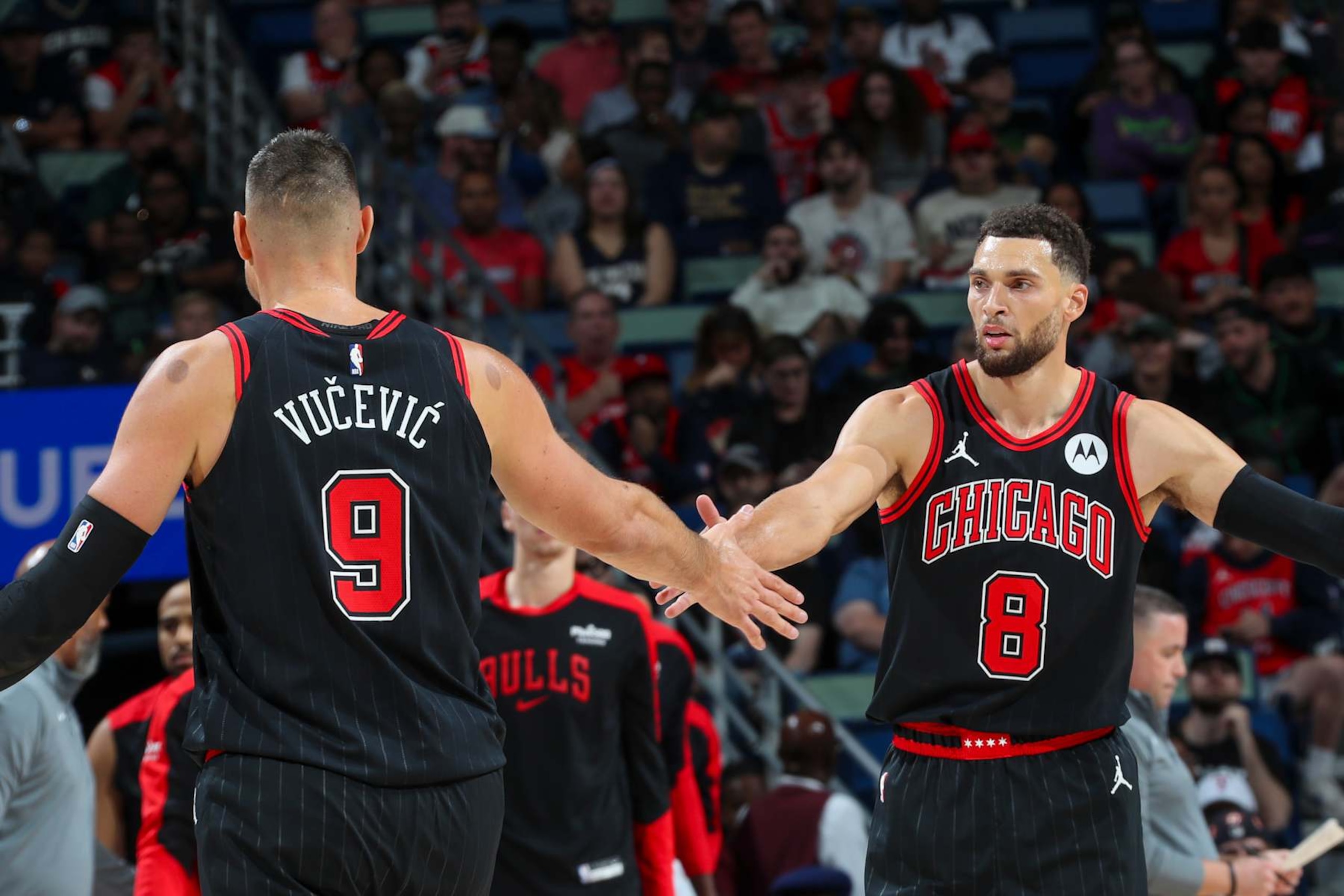 NEW ORLEANS, LA - OCTOBER 23: Zach LaVine #8 and Nikola Vucevic #9 of the Chicago Bulls high-five during the game on October 23, 2024 at the Smoothie King Center in New Orleans, Louisiana. NOTE TO USER: User expressly acknowledges and agrees that, by downloading and or using this Photograph, user is consenting to the terms and conditions of the Getty Images License Agreement. Mandatory Copyright Notice: Copyright 2024 NBAE (Photo by Layne Murdoch Jr./NBAE via Getty Images)