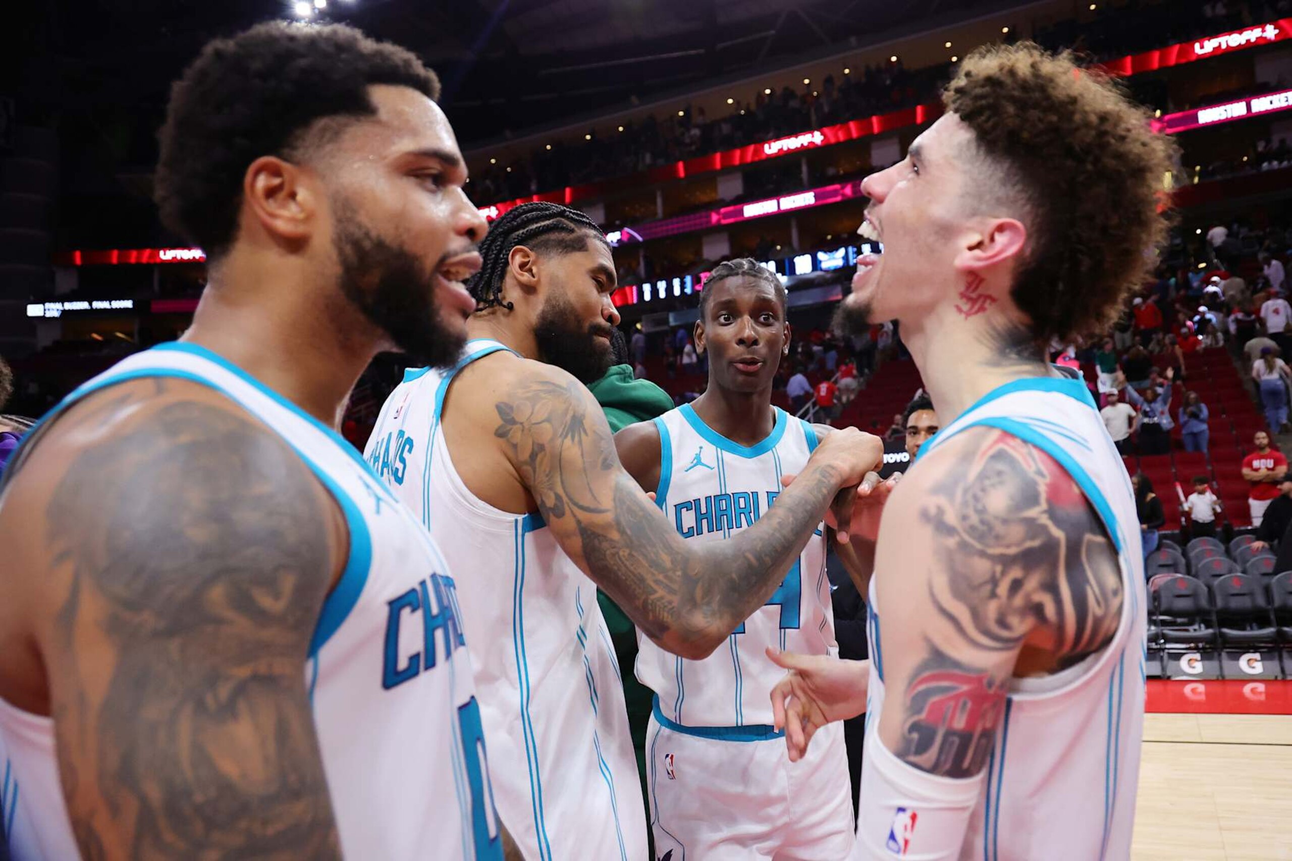 HOUSTON, TEXAS - OCTOBER 23: (L-R) Miles Bridges #0 of the Charlotte Hornets Nick Richards #4, Moussa Diabate #14 and LaMelo Ball #1 celebrate after defeating the Houston Rockets 110-105 at Toyota Center on October 23, 2024 in Houston, Texas.  NOTE TO USER: User expressly acknowledges and agrees that, by downloading and or using this photograph, User is consenting to the terms and conditions of the Getty Images License Agreement. (Photo by Alex Slitz/Getty Images)
