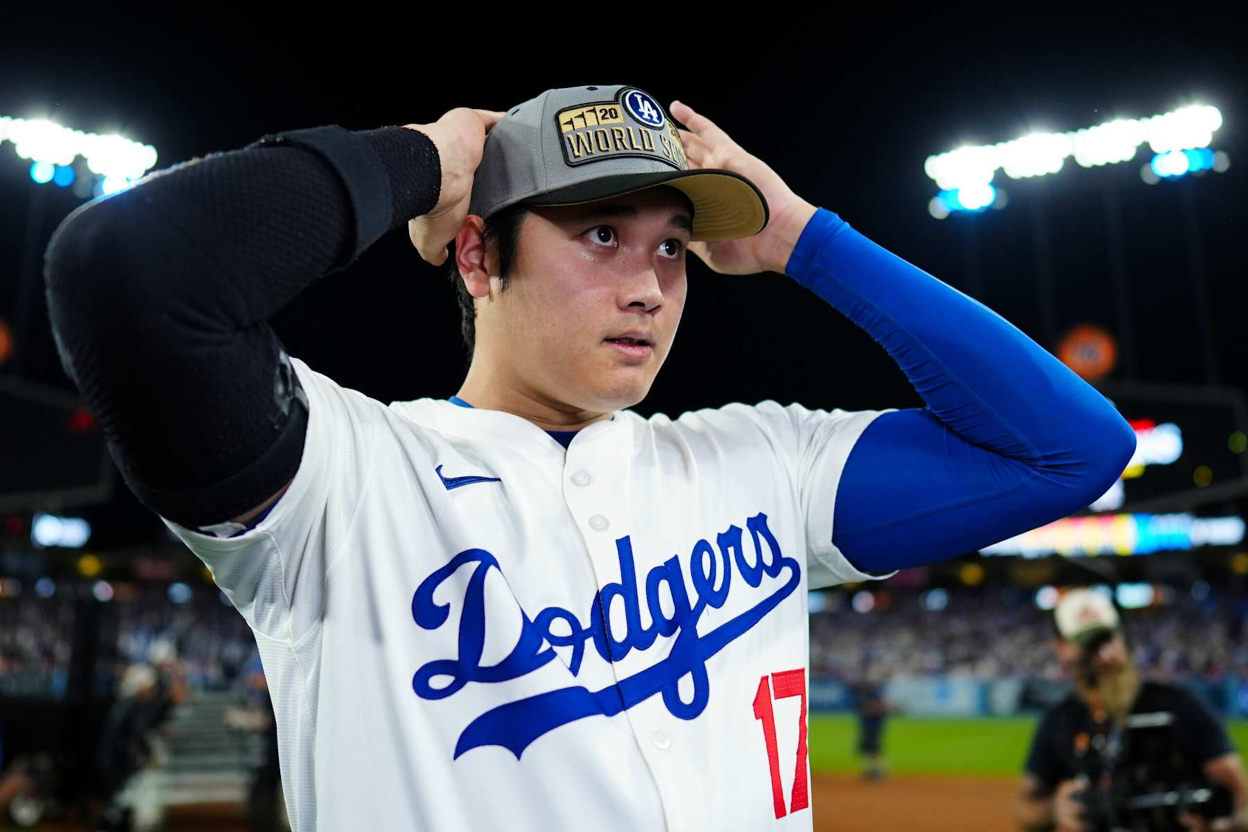 LOS ANGELES, CA - OCTOBER 20:   Shohei Ohtani #17 of the Los Angeles Dodgers puts a hat on to celebrate advancing to the World Series after winning Game 6 of the NLCS presented by loanDepot between the New York Mets and the Los Angeles Dodgers at Dodger Stadium on Sunday, October 20, 2024 in Los Angeles, California. (Photo by Daniel Shirey/MLB Photos via Getty Images)