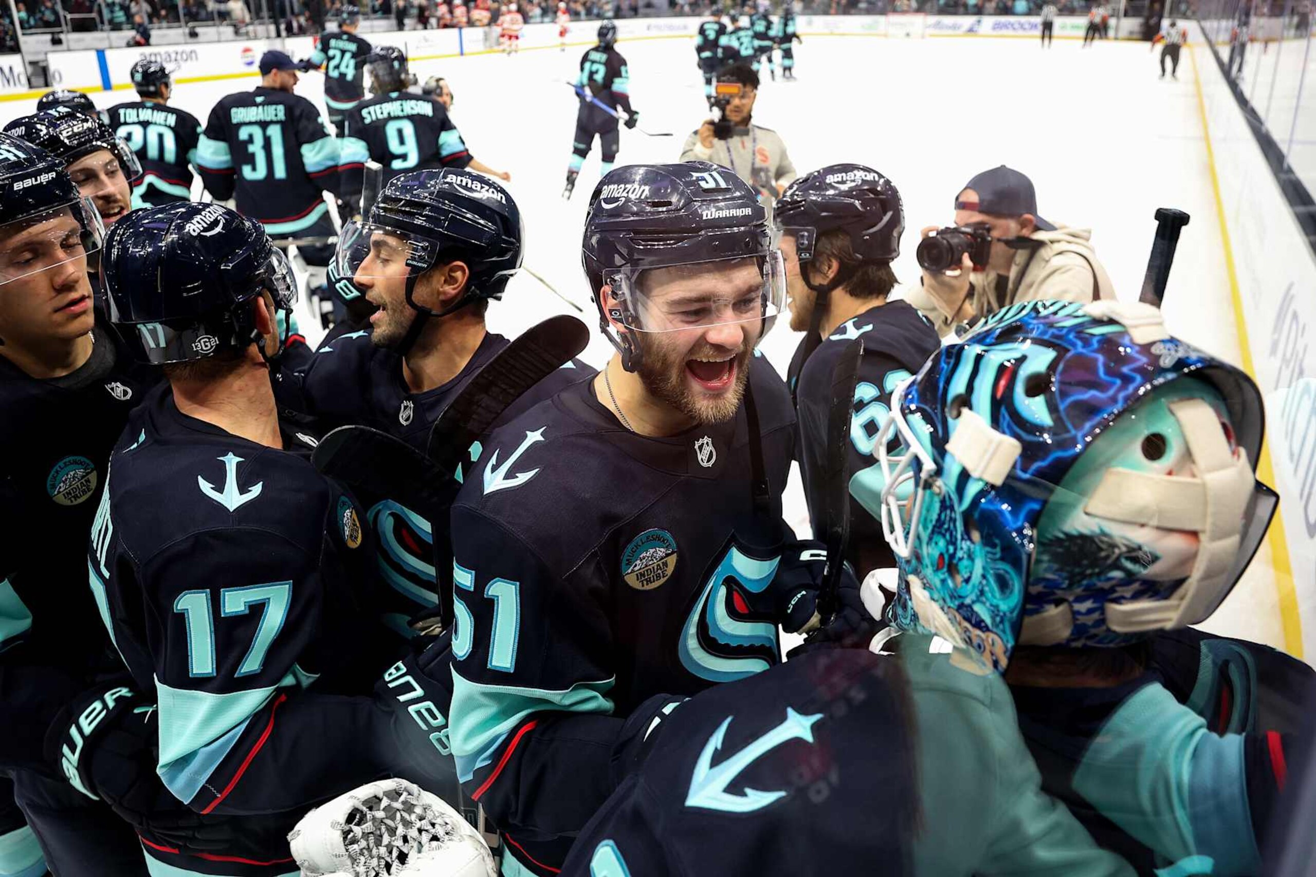 SEATTLE, WASHINGTON - OCTOBER 19: Shane Wright #51 and Joey Daccord #35 of the Seattle Kraken celebrate their 2-1 overtime win against the Calgary Flames at Climate Pledge Arena on October 19, 2024 in Seattle, Washington. (Photo by Steph Chambers/Getty Images)