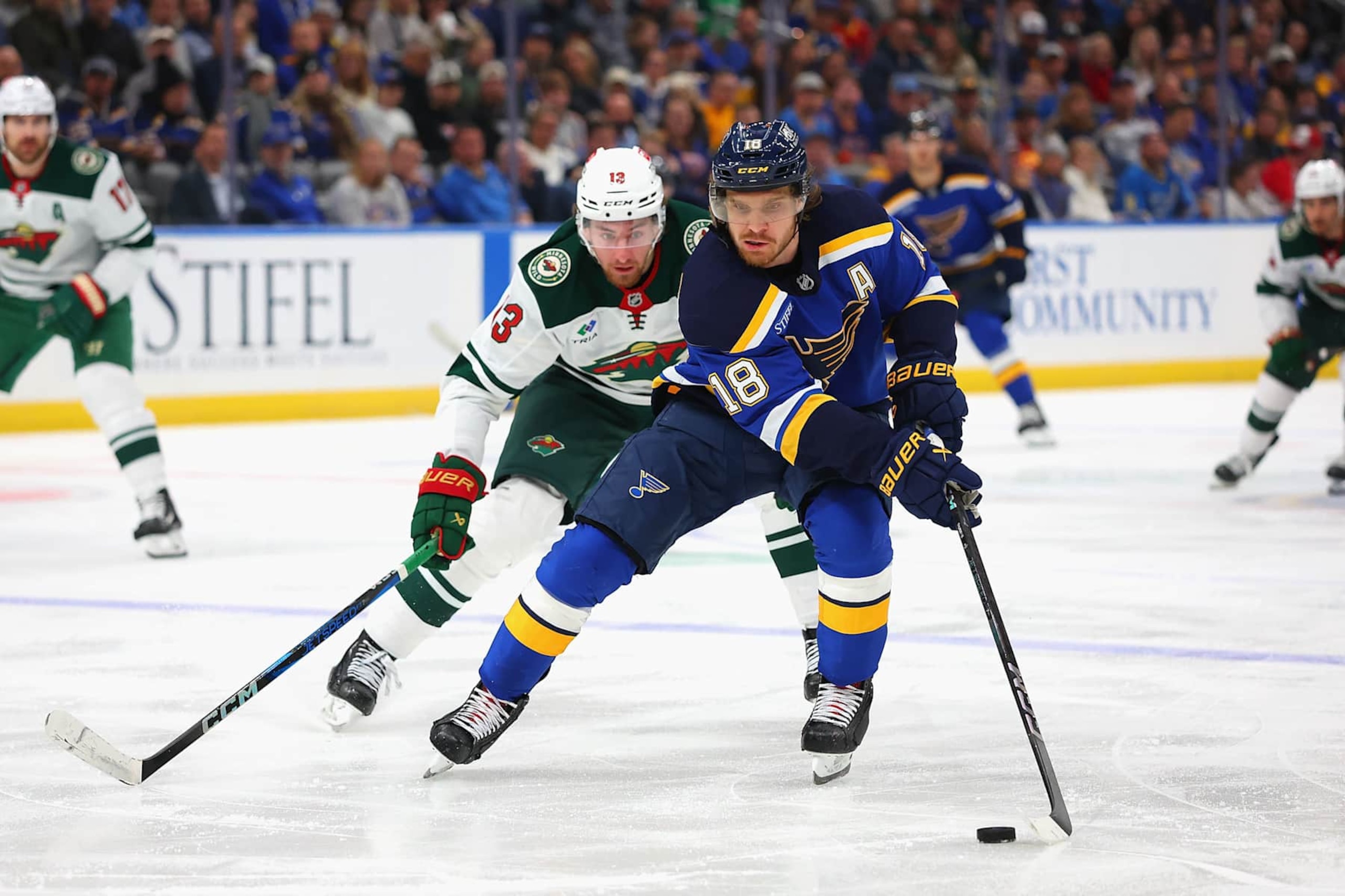 ST LOUIS, MISSOURI - OCTOBER 15: Robert Thomas #18 of the St. Louis Blues controls the puck against Yakov Trenin #13 of the Minnesota Wild in the third period at Enterprise Center on October 15, 2024 in St Louis, Missouri. (Photo by Dilip Vishwanat/Getty Images) ST LOUIS, MISSOURI - OCTOBER 15: Robert Thomas #18 of the St. Louis Blues controls the puck against Yakov Trenin #13 of the Minnesota Wild in the third period at Enterprise Center on October 15, 2024 in St Louis, Missouri. (Photo by Dilip Vishwanat/Getty Images)
