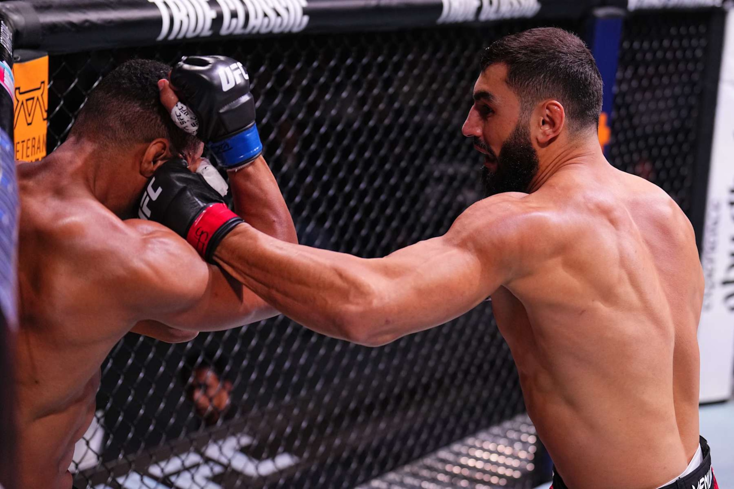 ABU DHABI, UNITED ARAB EMIRATES - OCTOBER 26: (R-L) Ibo Aslan of Turkey punches Rafael Cerqueira of Brazil in a light heavyweight fight during the UFC 308 event at Etihad Arena on October 26, 2024 in Abu Dhabi, United Arab Emirates.  (Photo by Chris Unger/Zuffa LLC)