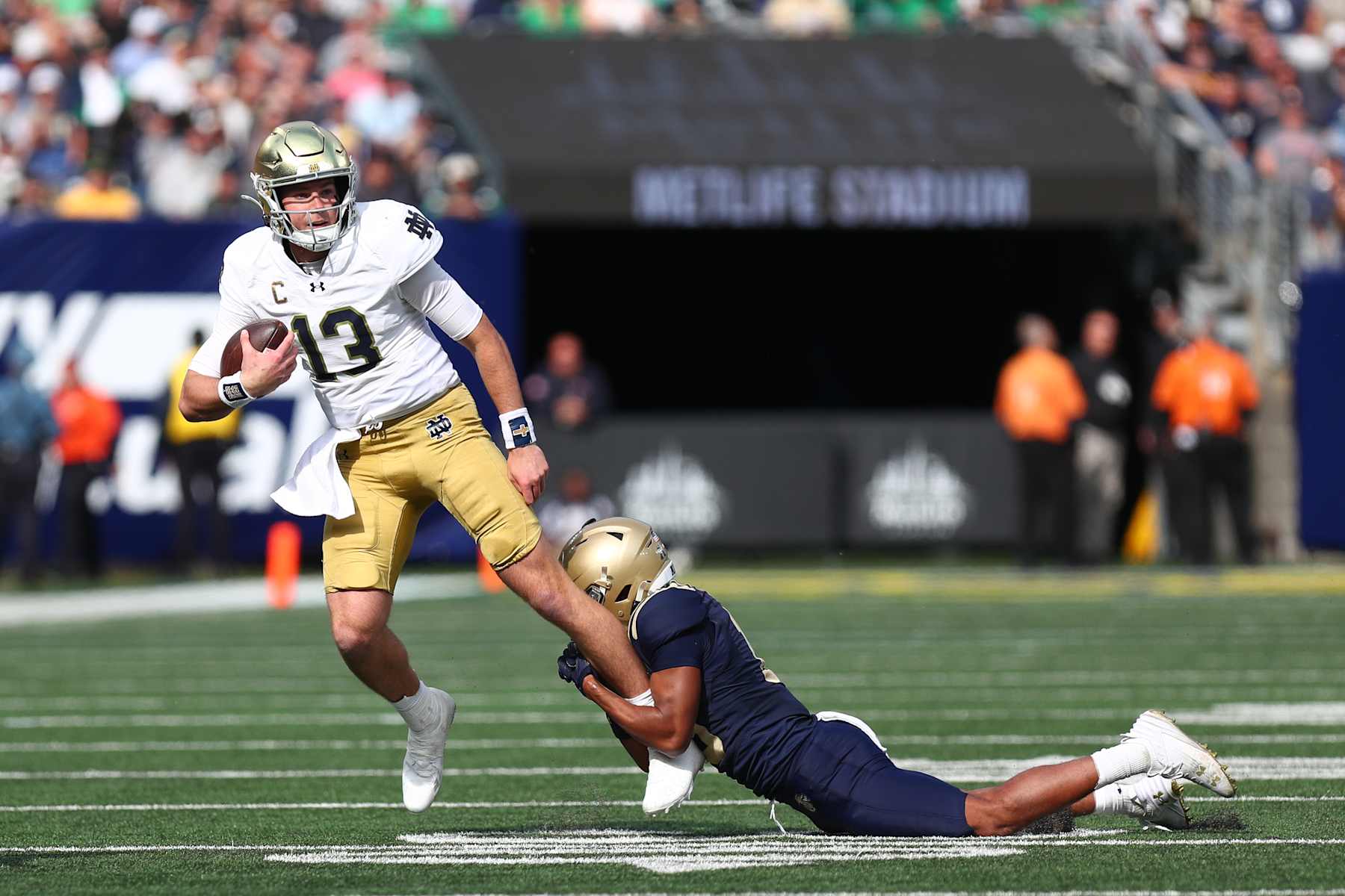 NEW YORK, NEW YORK - OCTOBER 26: Riley Leonard #13 of the Notre Dame Fighting Irish runs for a short gain in the first quarter against the Navy Midshipmen at Met Life Stadium on October 26, 2024 in New York City. (Photo by Edward Diller/Getty Images)