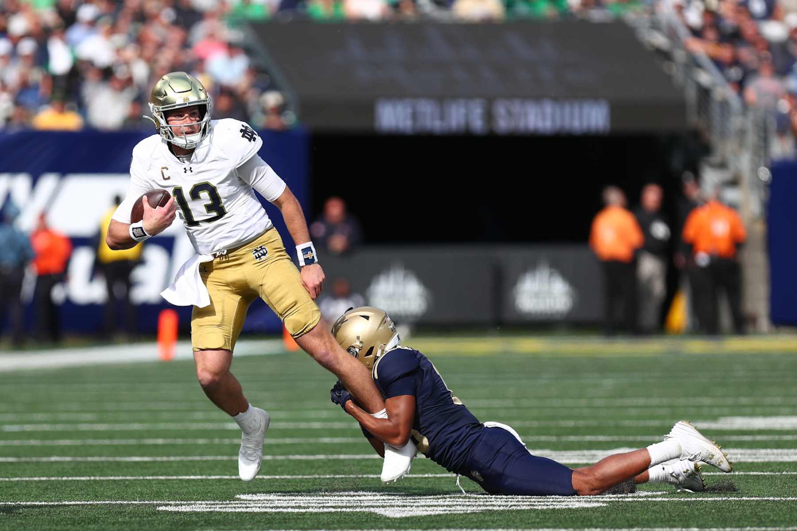 NEW YORK, NEW YORK - OCTOBER 26: Riley Leonard #13 of the Notre Dame Fighting Irish runs for a short gain in the first quarter against the Navy Midshipmen at Met Life Stadium on October 26, 2024 in New York City. (Photo by Edward Diller/Getty Images)