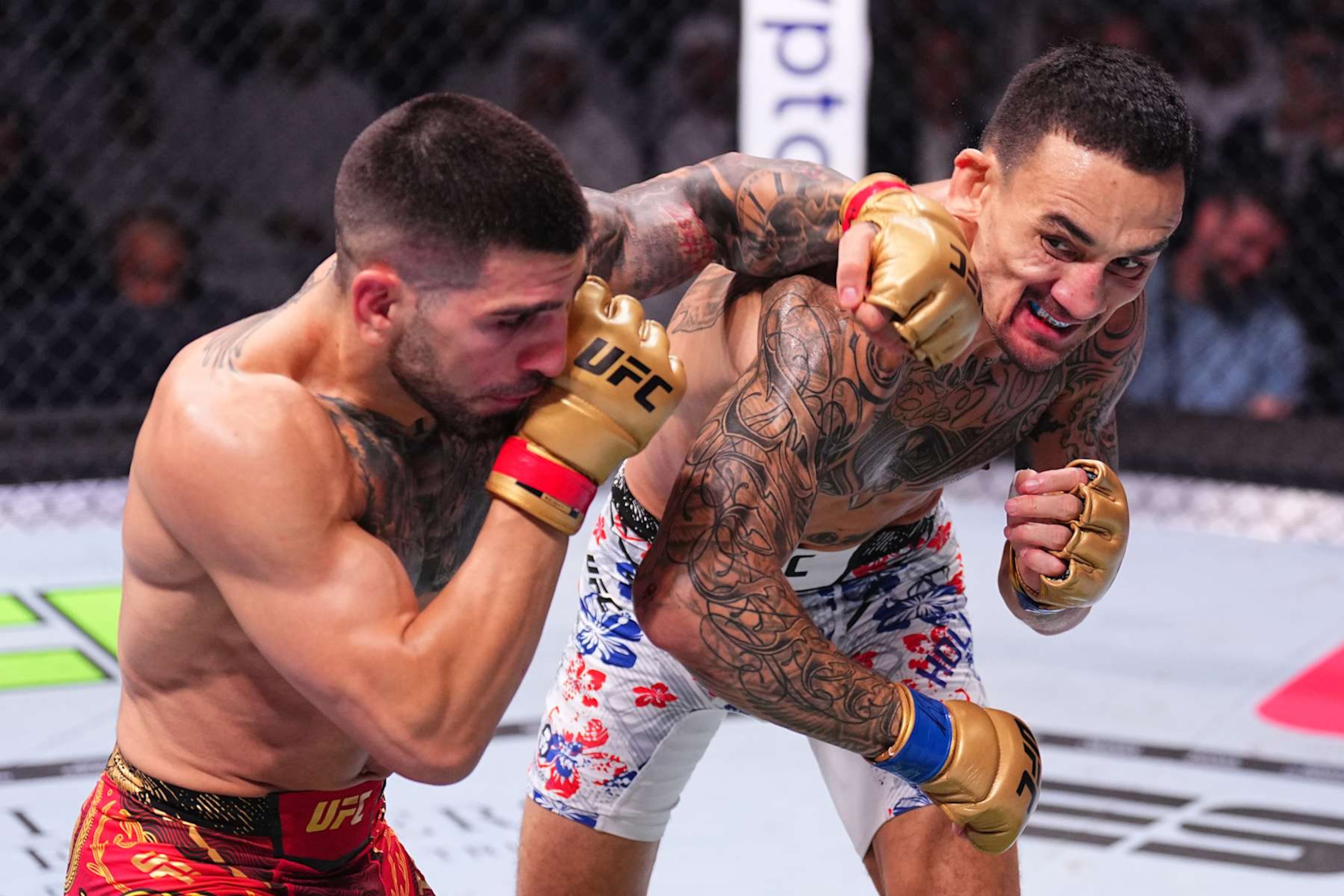 ABU DHABI, UNITED ARAB EMIRATES - OCTOBER 26: (L-R) Ilia Topuria of Spain punches Max Holloway in the UFC featherweight championship fight during the UFC 308 event at Etihad Arena on October 26, 2024 in Abu Dhabi, United Arab Emirates.  (Photo by Chris Unger/Zuffa LLC)