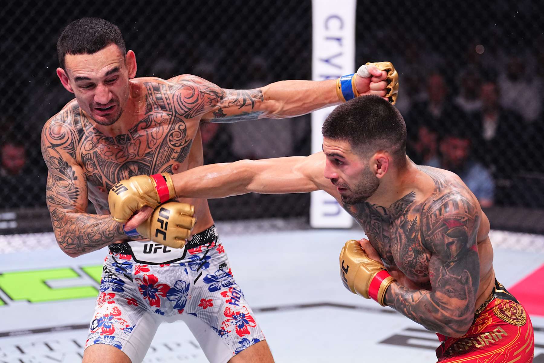 ABU DHABI, UNITED ARAB EMIRATES - OCTOBER 26: (R-L) Ilia Topuria of Spain punches Max Holloway in the UFC featherweight championship fight during the UFC 308 event at Etihad Arena on October 26, 2024 in Abu Dhabi, United Arab Emirates.  (Photo by Chris Unger/Zuffa LLC)