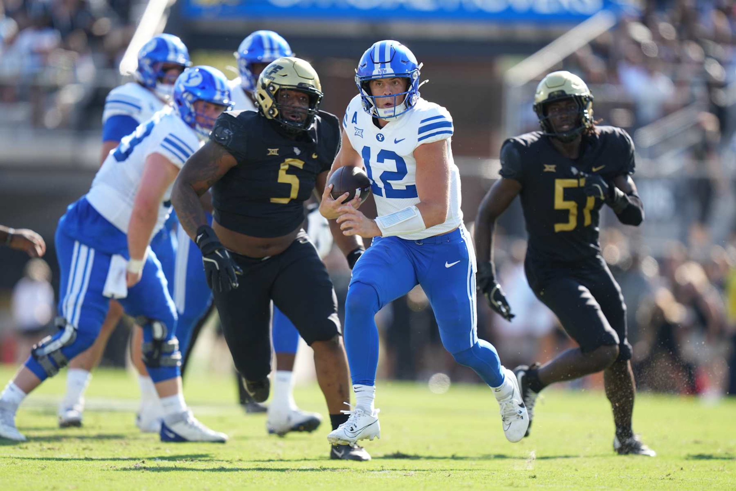 ORLANDO, FL - OCTOBER 26: Brigham Young Cougars quarterback Jake Retzlaff (12) runs with the ball during the game between the BYU Cougars and the UCF Knights on Saturday, October 26, 2024 at FBC Mortgage Stadium in Orlando, Fla. (Photo by Peter Joneleit/Icon Sportswire via Getty Images)