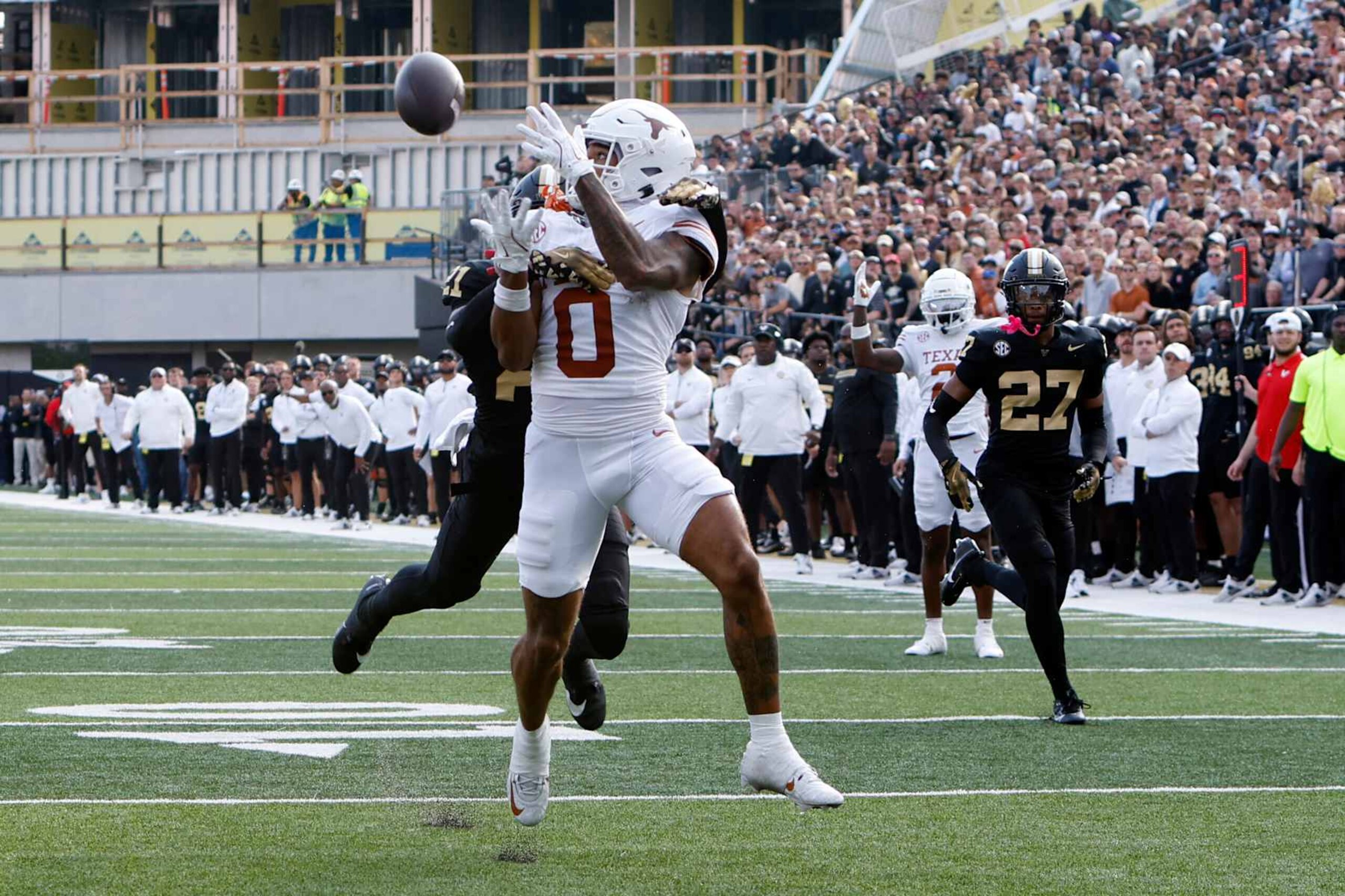 NASHVILLE, TN - OCTOBER 26: Texas Longhorns wide receiver DeAndre Moore Jr. (0) catches a touchdown in front of Vanderbilt Commodores safety Dontae Carter (21) during a game between the Vanderbilt Commodores and Texas Longhorns, October 26, 2024 at FirstBank Stadium in Nashville, Tennessee. (Photo by Matthew Maxey/Icon Sportswire via Getty Images)