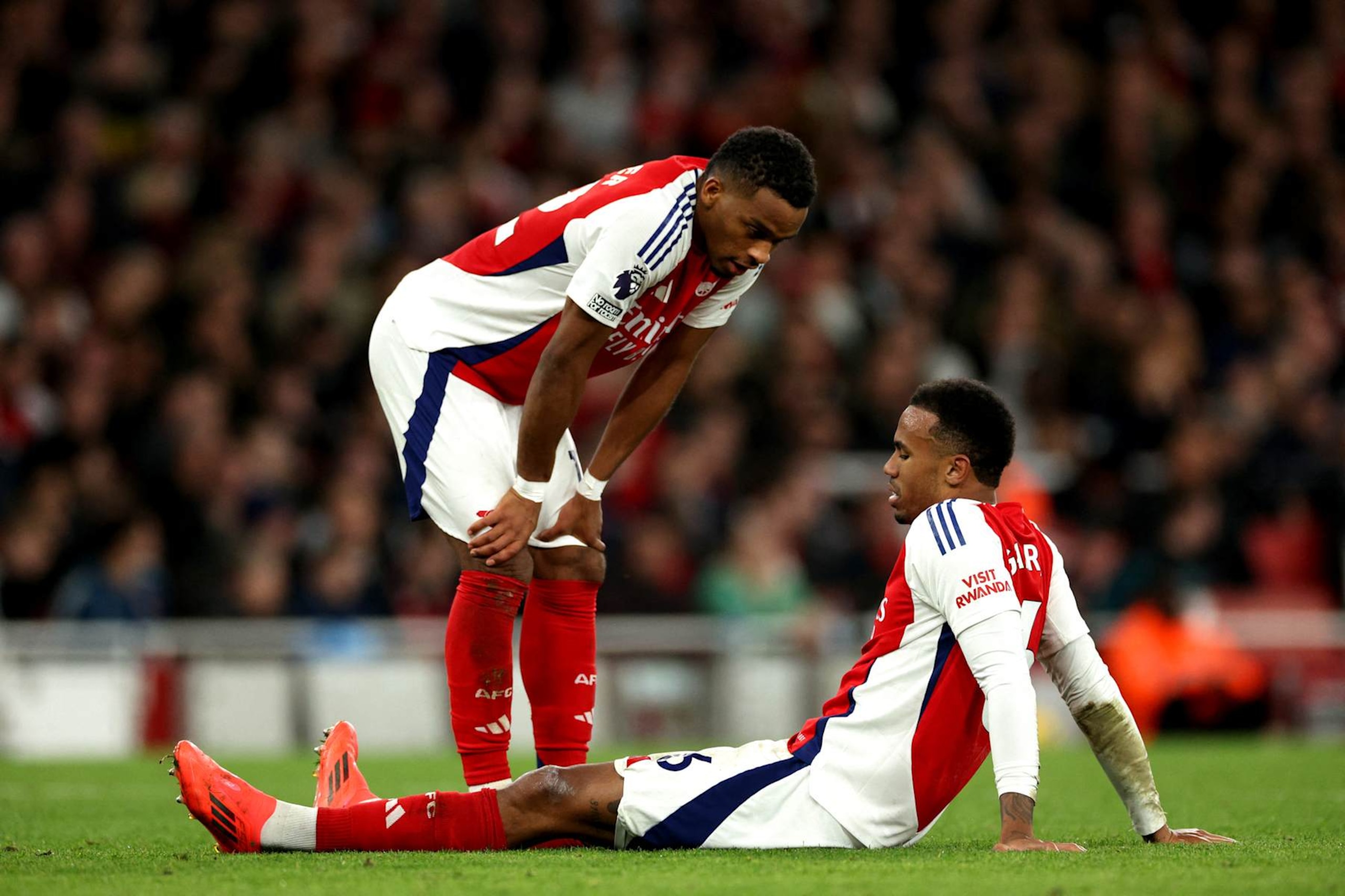 Arsenal's Brazilian defender #06 Gabriel Magalhaes sits on the floor injured during the English Premier League football match between Arsenal and Liverpool at the Emirates Stadium in London on October 27, 2024. (Photo by Adrian Dennis / AFP) / RESTRICTED TO EDITORIAL USE. No use with unauthorized audio, video, data, fixture lists, club/league logos or 'live' services. Online in-match use limited to 120 images. An additional 40 images may be used in extra time. No video emulation. Social media in-match use limited to 120 images. An additional 40 images may be used in extra time. No use in betting publications, games or single club/league/player publications. /  (Photo by ADRIAN DENNIS/AFP via Getty Images)