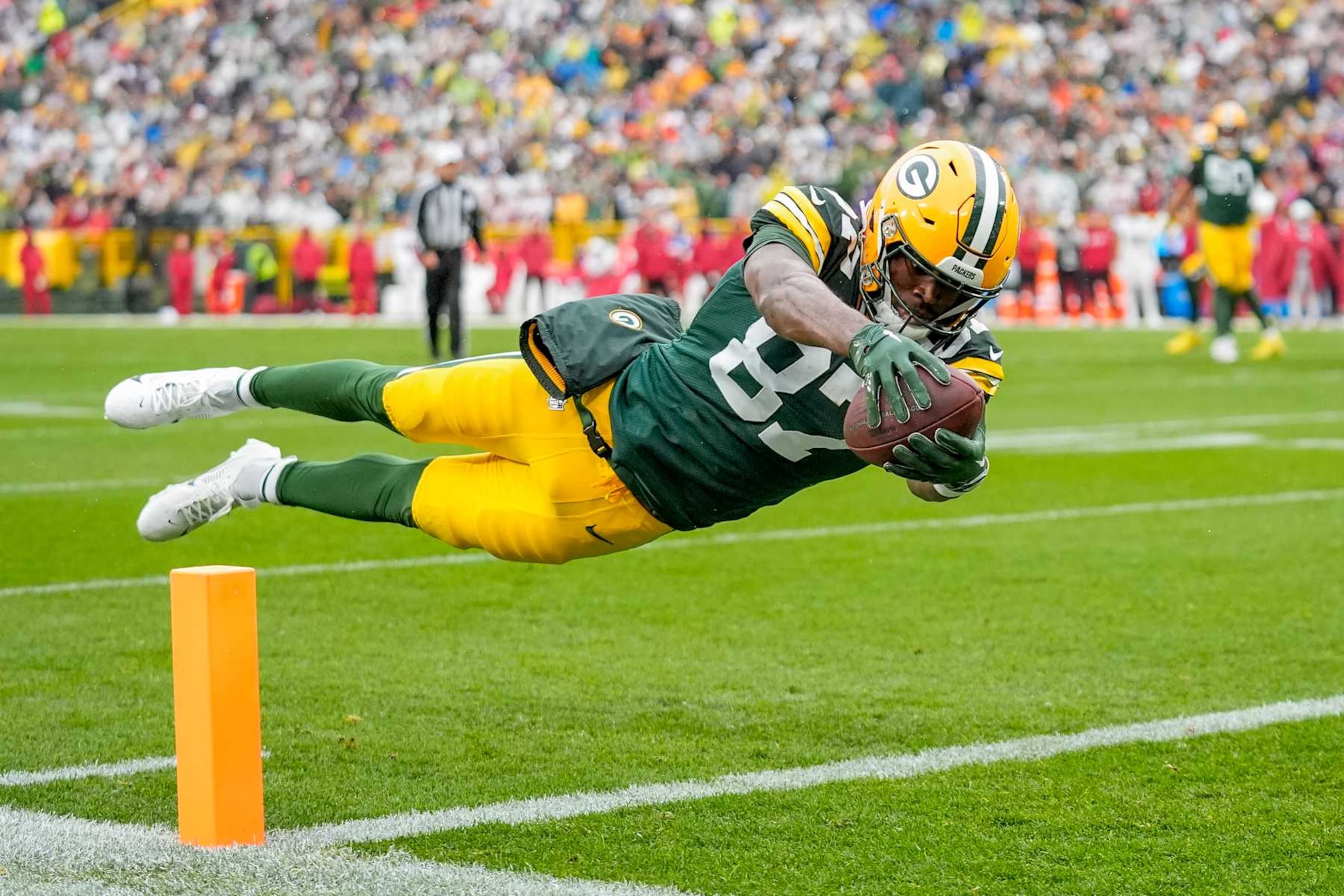 GREEN BAY, WISCONSIN - OCTOBER 13: Romeo Doubs #87 of the Green Bay Packers dives for a touchdown against the Arizona Cardinals during the second quarter of the game at Lambeau Field on October 13, 2024 in Green Bay, Wisconsin. (Photo by Patrick McDermott/Getty Images)