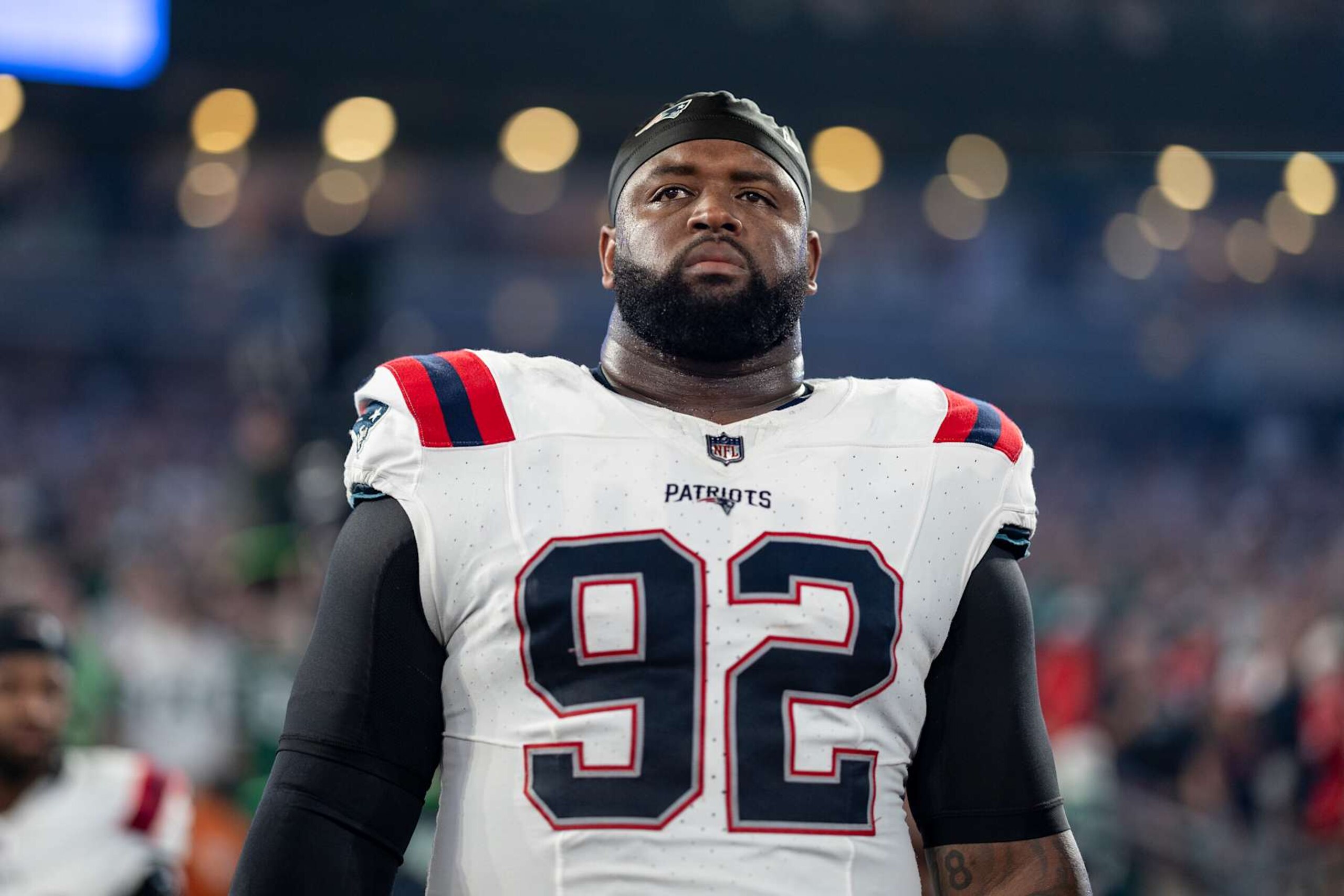 EAST RUTHERFORD, NEW JERSEY - SEPTEMBER 19: Davon Godchaux #92 of the New England Patriots looks on during the national anthem prior to an NFL football game between the New York Jets and the New England Patriots at MetLife Stadium on September 19, 2024 in East Rutherford, New Jersey. (Photo by Michael Owens/Getty Images)