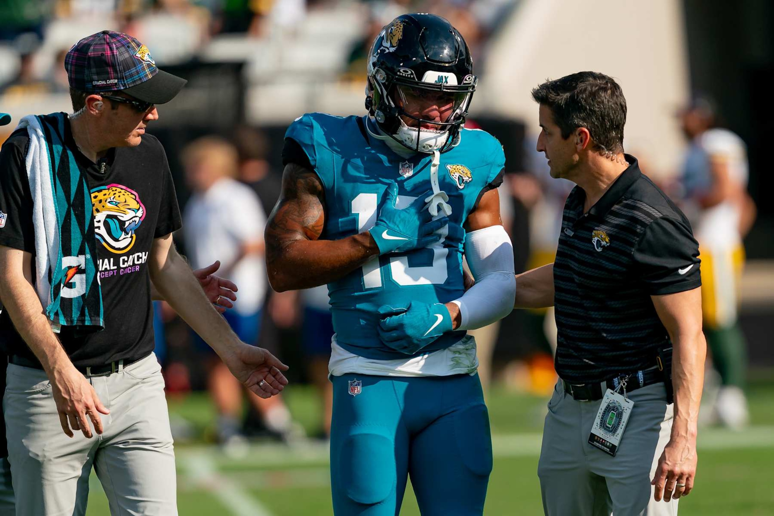 JACKSONVILLE, FL - OCTOBER 27:  Jacksonville Jaguars wide receiver Christian Kirk (13) is helped off the field after an injury during a NFL football game between the Green Bay Packers and the Jacksonville Jaguars on October 27th, 2024 at EverBank Stadium in Jacksonville, FL. (Photo by Chris Leduc/Icon Sportswire via Getty Images)