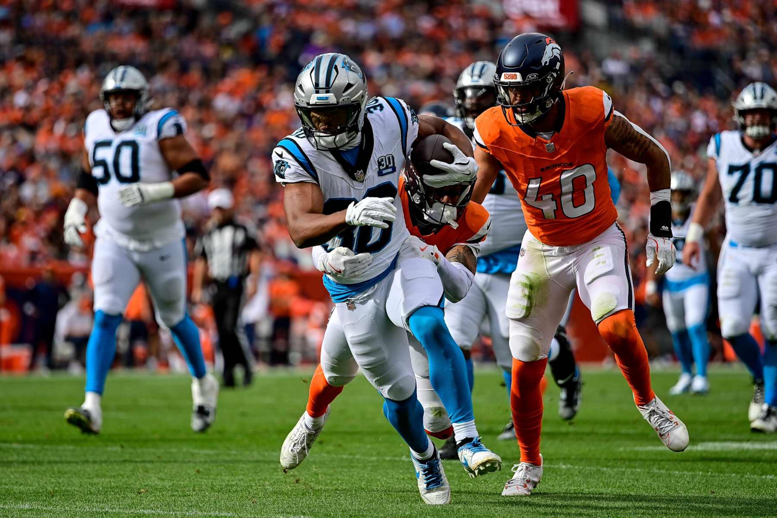 DENVER, CO - OCTOBER 27: Carolina Panthers running back Chuba Hubbard (30) carries the ball against the Denver Broncos in the first half during a game between the Carolina Panthers and the Denver Broncos at Empower Field at Mile High on October 27, 2024 in Denver, Colorado. (Photo by Dustin Bradford/Icon Sportswire via Getty Images)