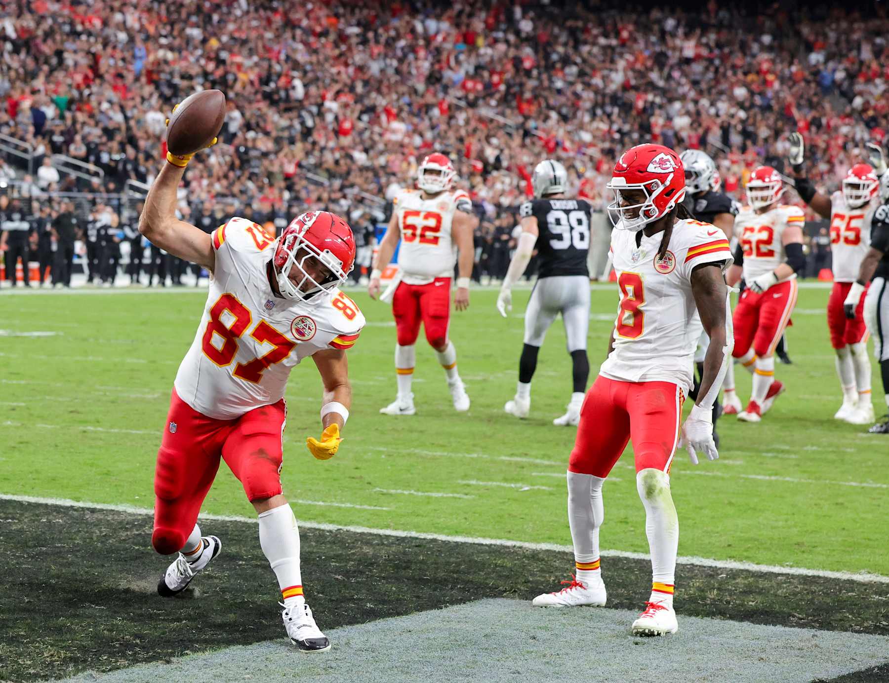 LAS VEGAS, NEVADA - OCTOBER 27: Travis Kelce #87 of the Kansas City Chiefs spikes the football in the end zone after catching a 5-yard pass for a touchdown against the Las Vegas Raiders as DeAndre Hopkins #8 of the Chiefs looks on in the second quarter of their game at Allegiant Stadium on October 27, 2024 in Las Vegas, Nevada. The Chiefs defeated the Raiders 27-20. (Photo by Ethan Miller/Getty Images)