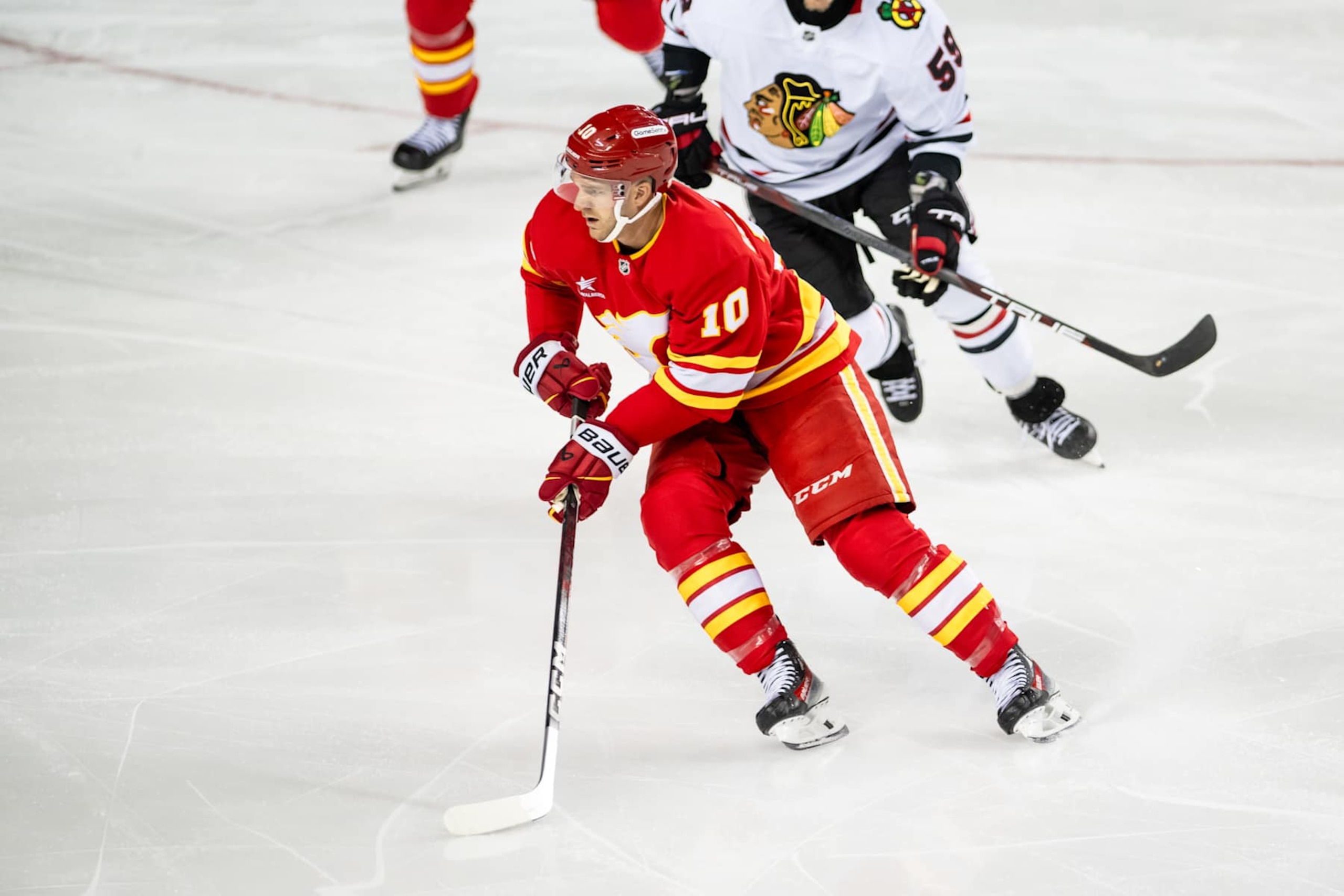 CALGARY, AB - OCTOBER 15: Calgary Flames Left Wing Jonathan Huberdeau (10) skates with the puck during the first period of an NHL game between the Calgary Flames and the Chicago Blackhawks on October 15, 2024, at the Scotiabank Saddledome in Calgary, AB. (Photo by Brett Holmes/Icon Sportswire via Getty Images)
