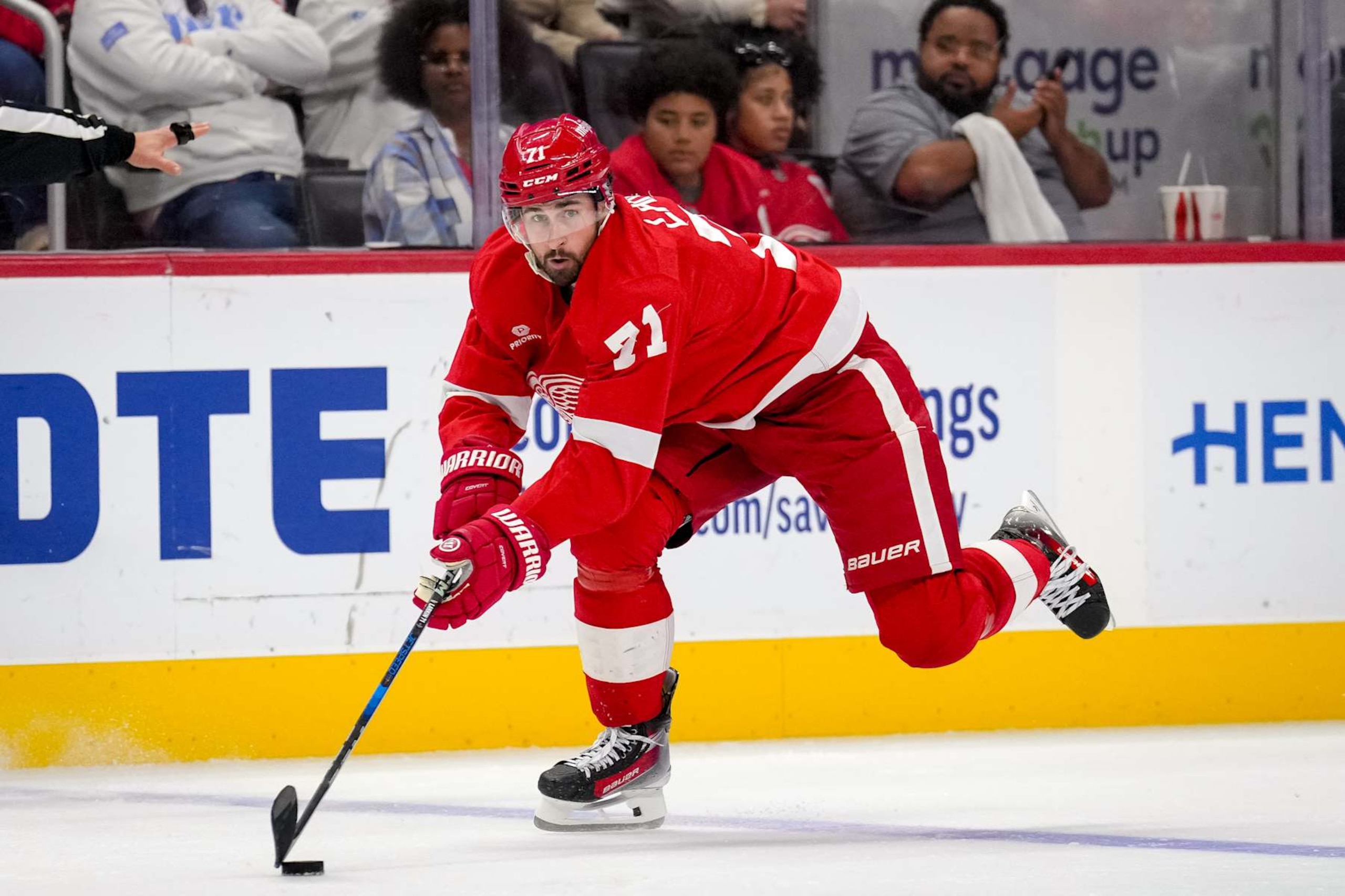 DETROIT, MICHIGAN - OCTOBER 24: Dylan Larkin #71 of the Detroit Red Wings skates with the puck against against the New Jersey Devils during the second period at Little Caesars Arena on October 24, 2024 in Detroit, Michigan. (Photo by Nic Antaya/Getty Images)