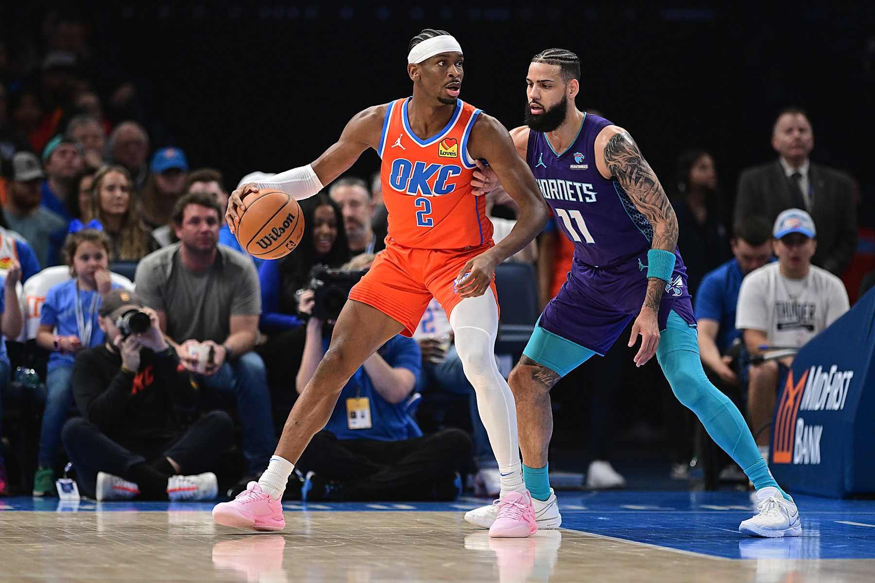OKLAHOMA CITY, OKLAHOMA - FEBRUARY 2: Shai Gilgeous-Alexander #2 of the Oklahoma City Thunder backs down Cody Martin #11 of the Charlotte Hornets during the first half at Paycom Center on February 2, 2024 in Oklahoma City, Oklahoma. NOTE TO USER: User expressly acknowledges and agrees that, by downloading and or using this Photograph, user is consenting to the terms and conditions of the Getty Images License Agreement. (Photo by Joshua Gateley/Getty Images)