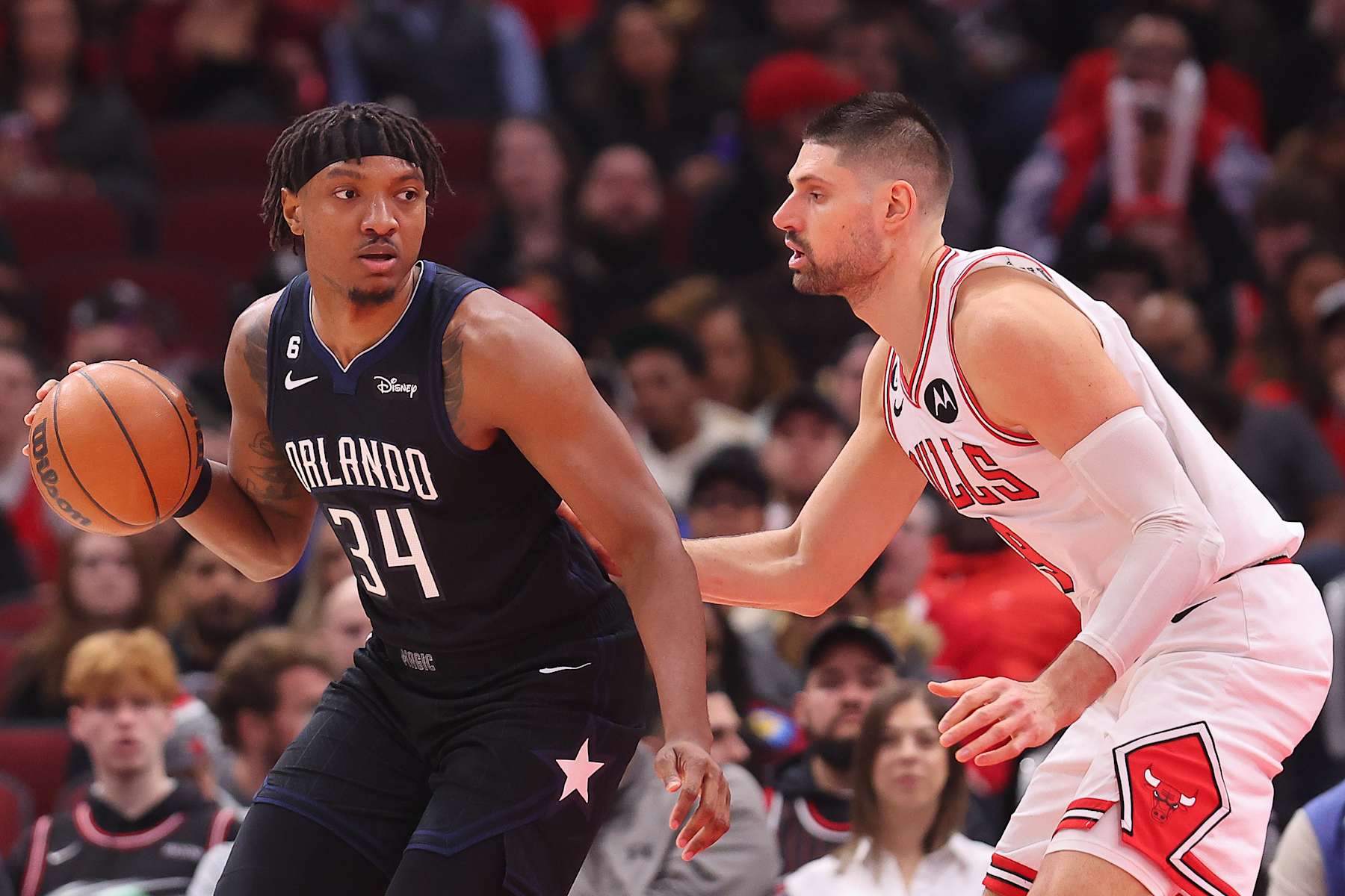 CHICAGO, ILLINOIS - FEBRUARY 13: Wendell Carter Jr. #34 of the Orlando Magic drives to the basket against Nikola Vucevic #9 of the Chicago Bulls during the second half at United Center on February 13, 2023 in Chicago, Illinois. NOTE TO USER: User expressly acknowledges and agrees that, by downloading and or using this photograph, User is consenting to the terms and conditions of the Getty Images License Agreement.  (Photo by Michael Reaves/Getty Images)