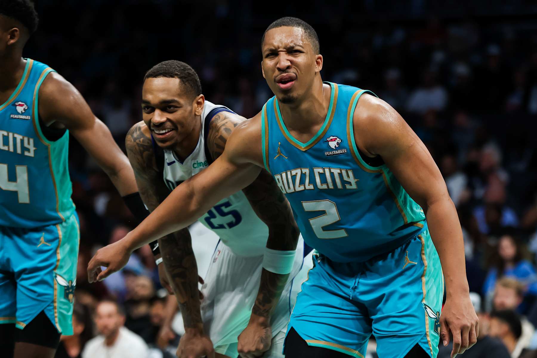 CHARLOTTE, NORTH CAROLINA - APRIL 09: P.J. Washington #25 of the Dallas Mavericks smiles as Grant Williams #2 of the Charlotte Hornets speaks with the referee during the second half of an NBA game at Spectrum Center on April 09, 2024 in Charlotte, North Carolina. NOTE TO USER: User expressly acknowledges and agrees that, by downloading and or using this photograph, User is consenting to the terms and conditions of the Getty Images License Agreement. (Photo by David Jensen/Getty Images)
