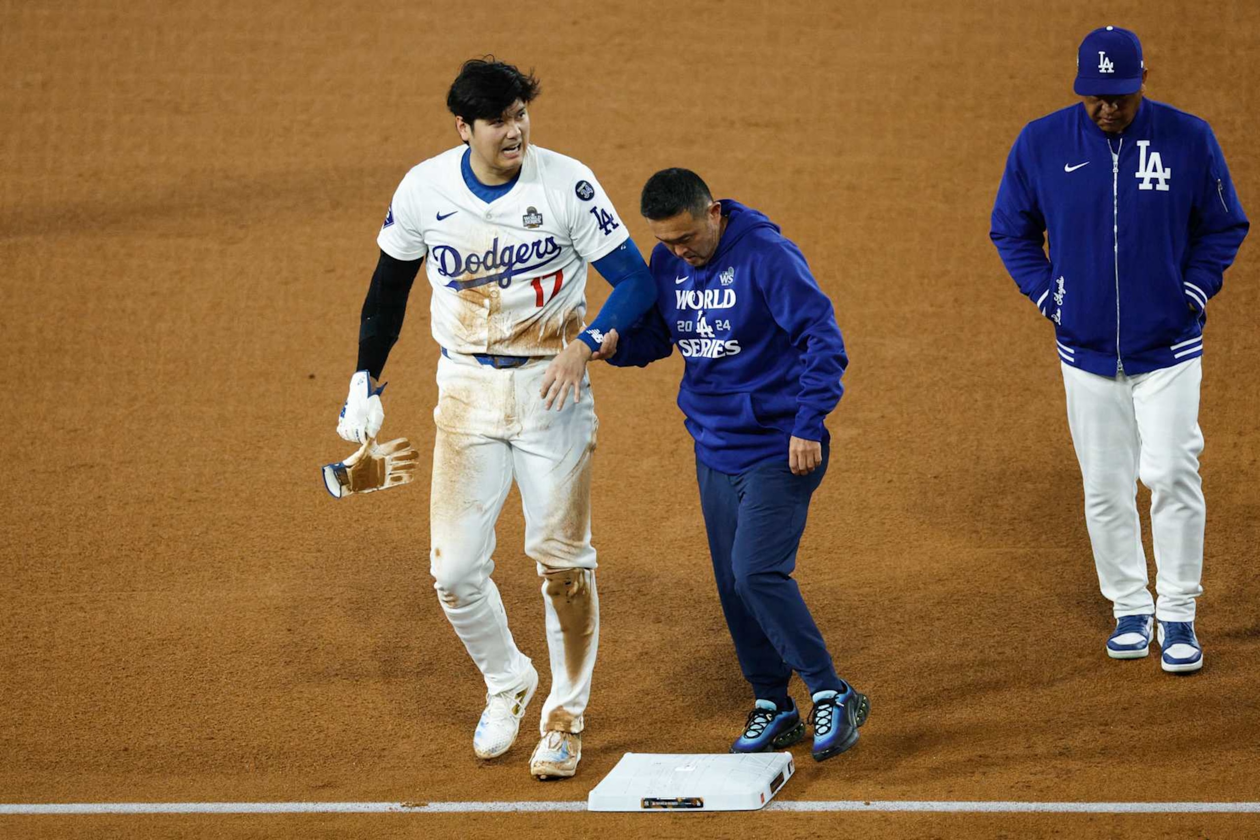 LOS ANGELES, CALIFORNIA - OCTOBER 26: Shohei Ohtani #17 of the Los Angeles Dodgers walks off the field after being injured while attempting to steal second base as they play against the New York Yankees in the seventh inning during Game Two of the 2024 World Series at Dodger Stadium on October 26, 2024 in Los Angeles, California. (Photo by Kevork Djansezian/Getty Images)