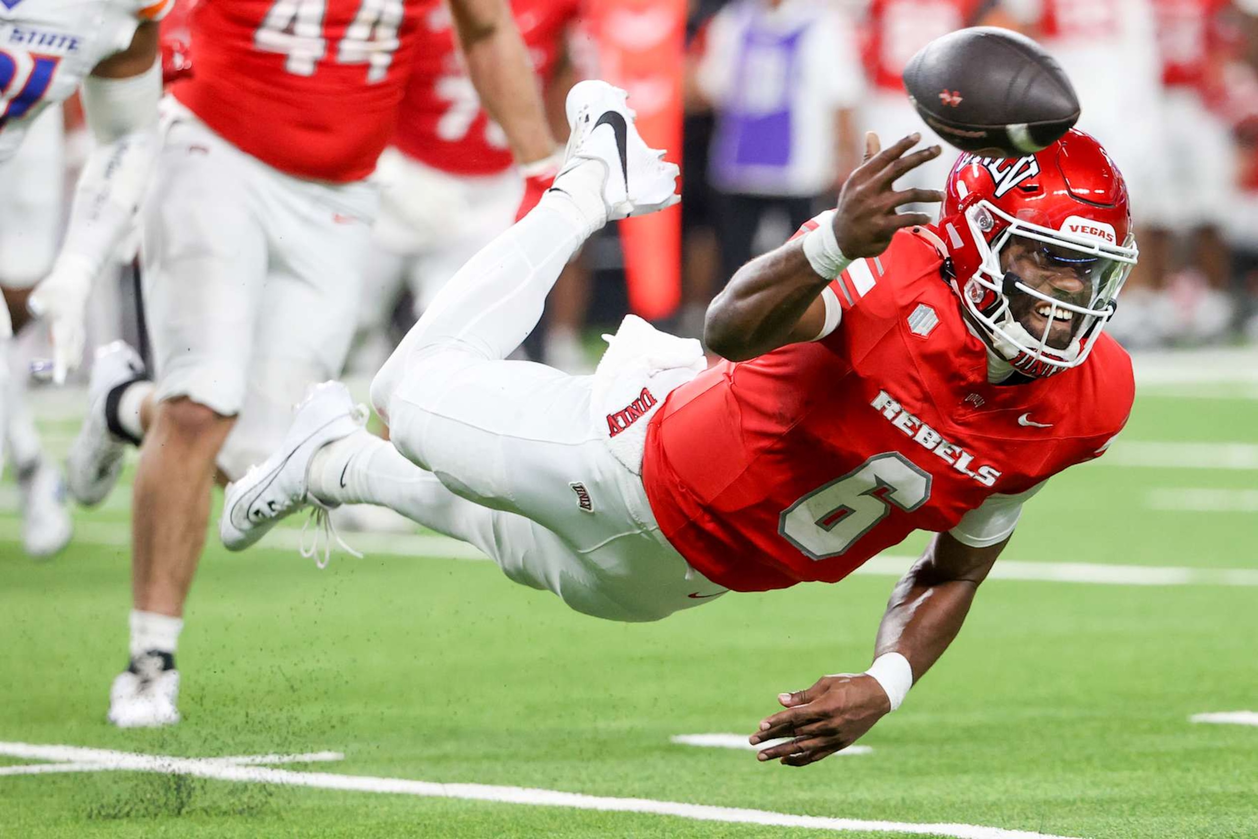 LAS VEGAS, NEVADA - OCTOBER 25: Hajj-Malik Williams #6 of the UNLV Rebels falls while attempting a pass during the third quarter of a game against the Boise State Broncos at Allegiant Stadium on October 25, 2024 in Las Vegas, Nevada. (Photo by Ian Maule/Getty Images) LAS VEGAS, NEVADA - OCTOBER 25: Hajj-Malik Williams #6 of the UNLV Rebels falls while attempting a pass during the third quarter of a game against the Boise State Broncos at Allegiant Stadium on October 25, 2024 in Las Vegas, Nevada. (Photo by Ian Maule/Getty Images)