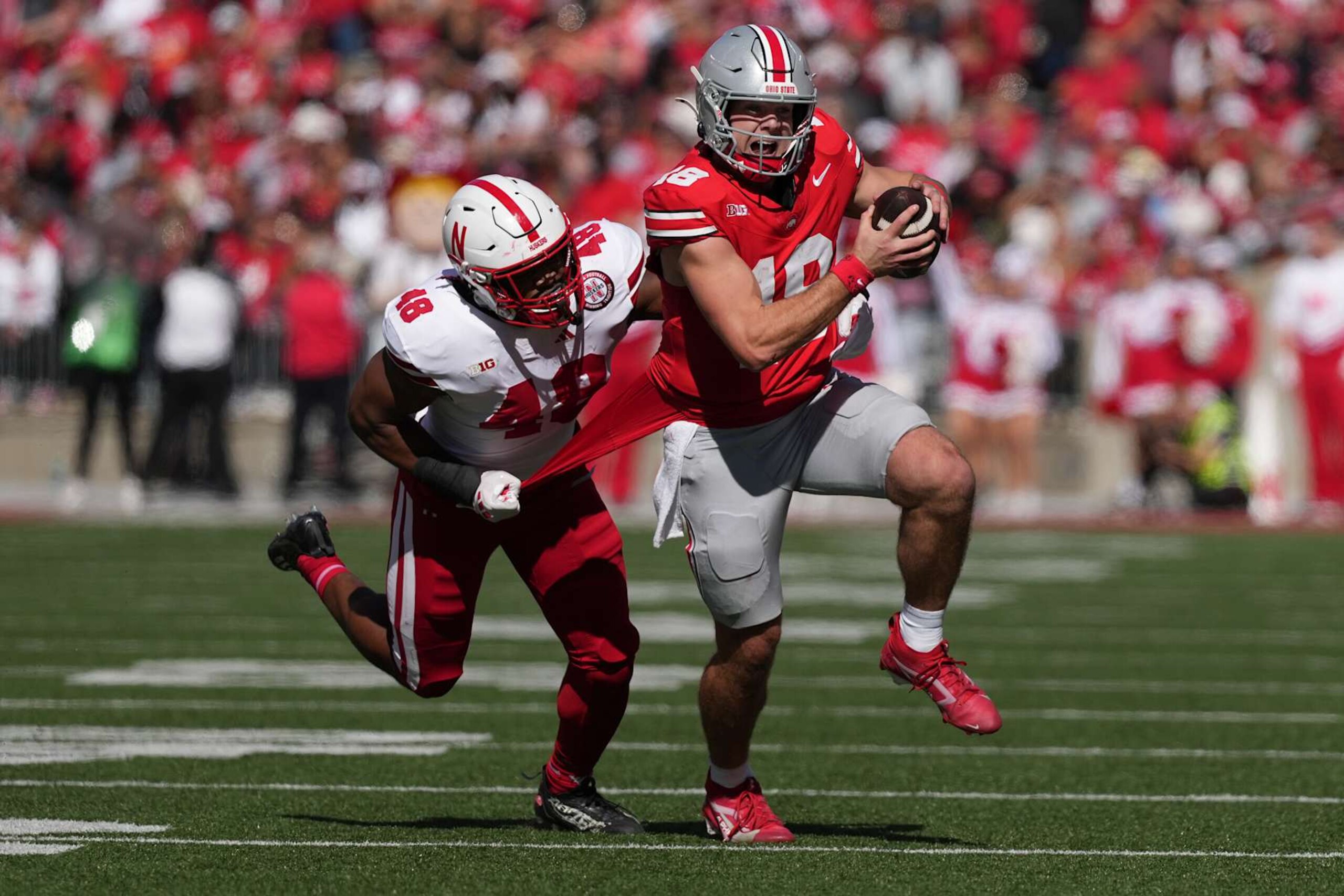 COLUMBUS, OHIO - OCTOBER 26: Quarterback Will Howard #18 of the Ohio State Buckeyes carries the ball while being tackled by linebacker MJ Sherman #48 of the Nebraska Cornhuskers during the second quarter at Ohio Stadium on October 26, 2024 in Columbus, Ohio. (Photo by Jason Mowry/Getty Images) COLUMBUS, OHIO - OCTOBER 26: Quarterback Will Howard #18 of the Ohio State Buckeyes carries the ball while being tackled by linebacker MJ Sherman #48 of the Nebraska Cornhuskers during the second quarter at Ohio Stadium on October 26, 2024 in Columbus, Ohio. (Photo by Jason Mowry/Getty Images)