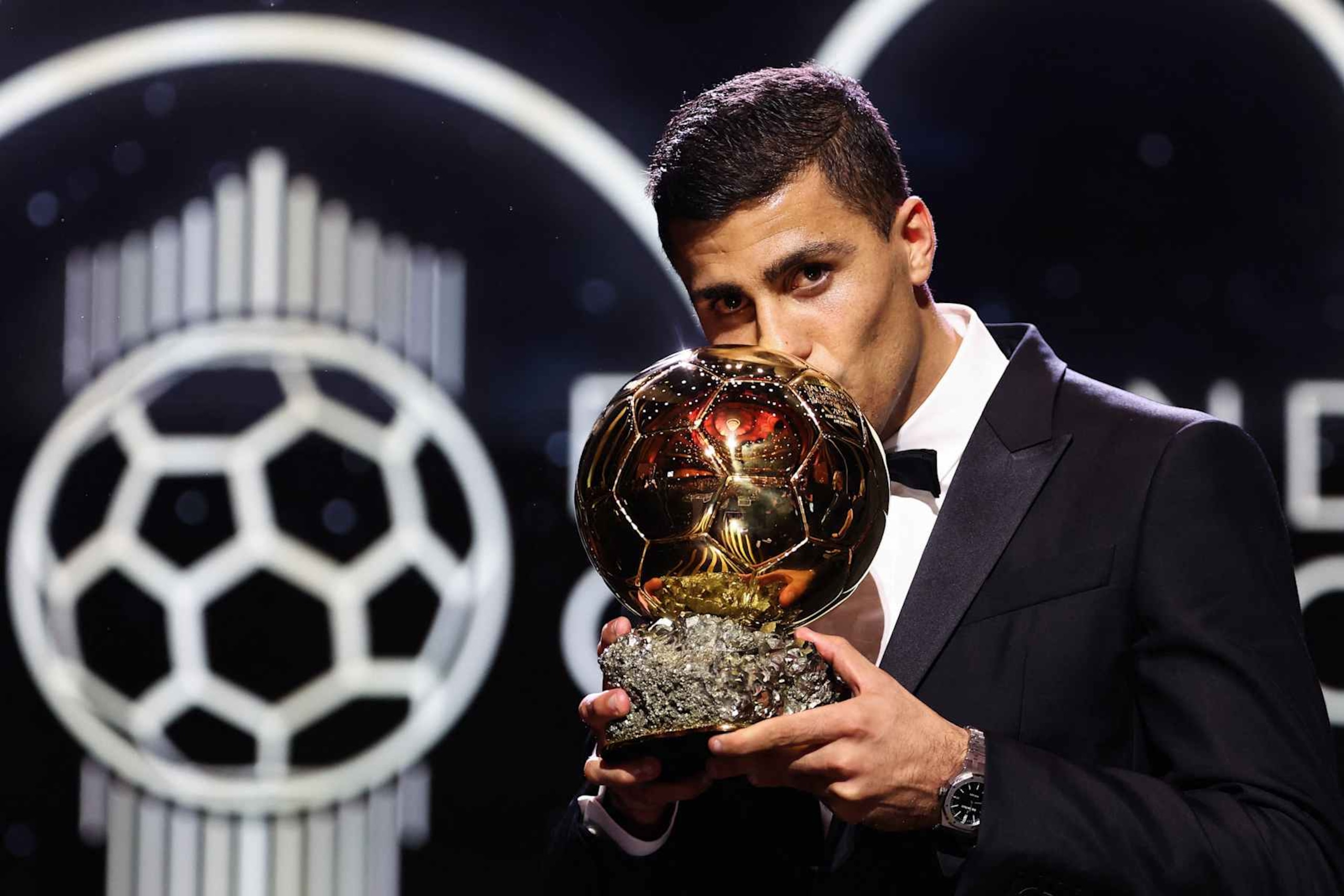 Manchester City's Spanish midfielder Rodri kisses the trophy as he receives the Ballon d'Or award during the 2024 Ballon d'Or France Football award ceremony at the Theatre du Chatelet in Paris on October 28, 2024. (Photo by FRANCK FIFE / AFP) (Photo by FRANCK FIFE/AFP via Getty Images)
