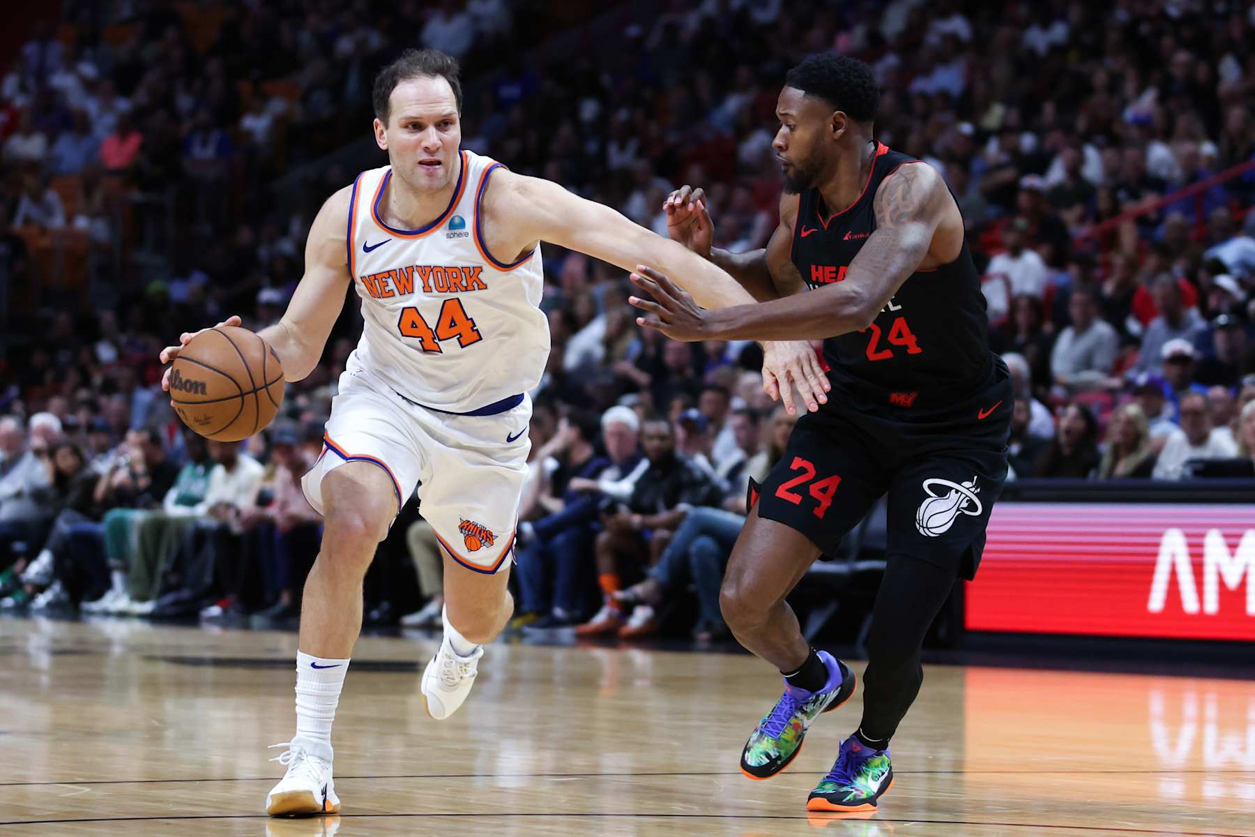 MIAMI, FLORIDA - APRIL 02: Bojan Bogdanovic #44 of the New York Knicks drives against Haywood Highsmith #24 of the Miami Heat during the second quarter of the game at Kaseya Center on April 02, 2024 in Miami, Florida. NOTE TO USER: User expressly acknowledges and agrees that, by downloading and or using this photograph, User is consenting to the terms and conditions of the Getty Images License Agreement. (Photo by Megan Briggs/Getty Images)