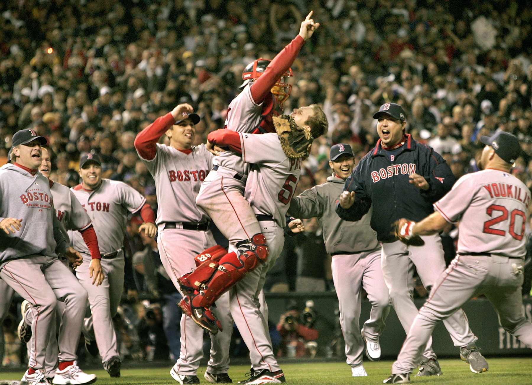 DENVER - OCTOBER 28: Jason Varitek  and Jonathan Papelbon celebrate the final out against the Rockies as the rest of the team join in the celebration. (Photo by Barry Chin/The Boston Globe via Getty Images)
