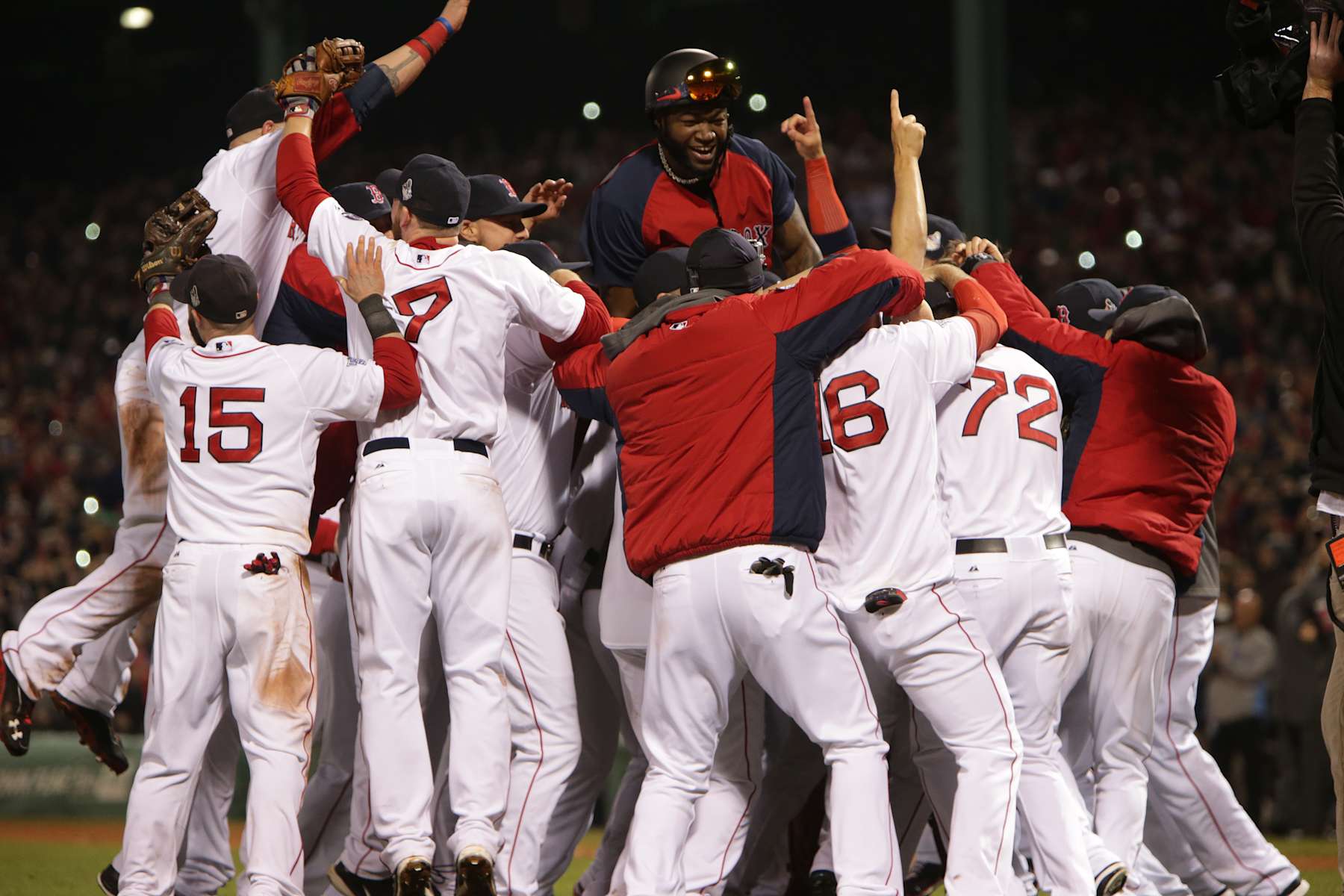 BOSTON - OCTOBER 30: Red Sox David Ortiz jumps up in a pile of teammates after the Red Sox defeated the Cardinals 6-1 to win the World Series. The Boston Red Sox host the St. Louis Cardinals at Fenway Park for Game Six of the 2013 Major League Baseball World Series, Oct. 30, 2013. (Photo by Barry Chin/The Boston Globe via Getty Images)