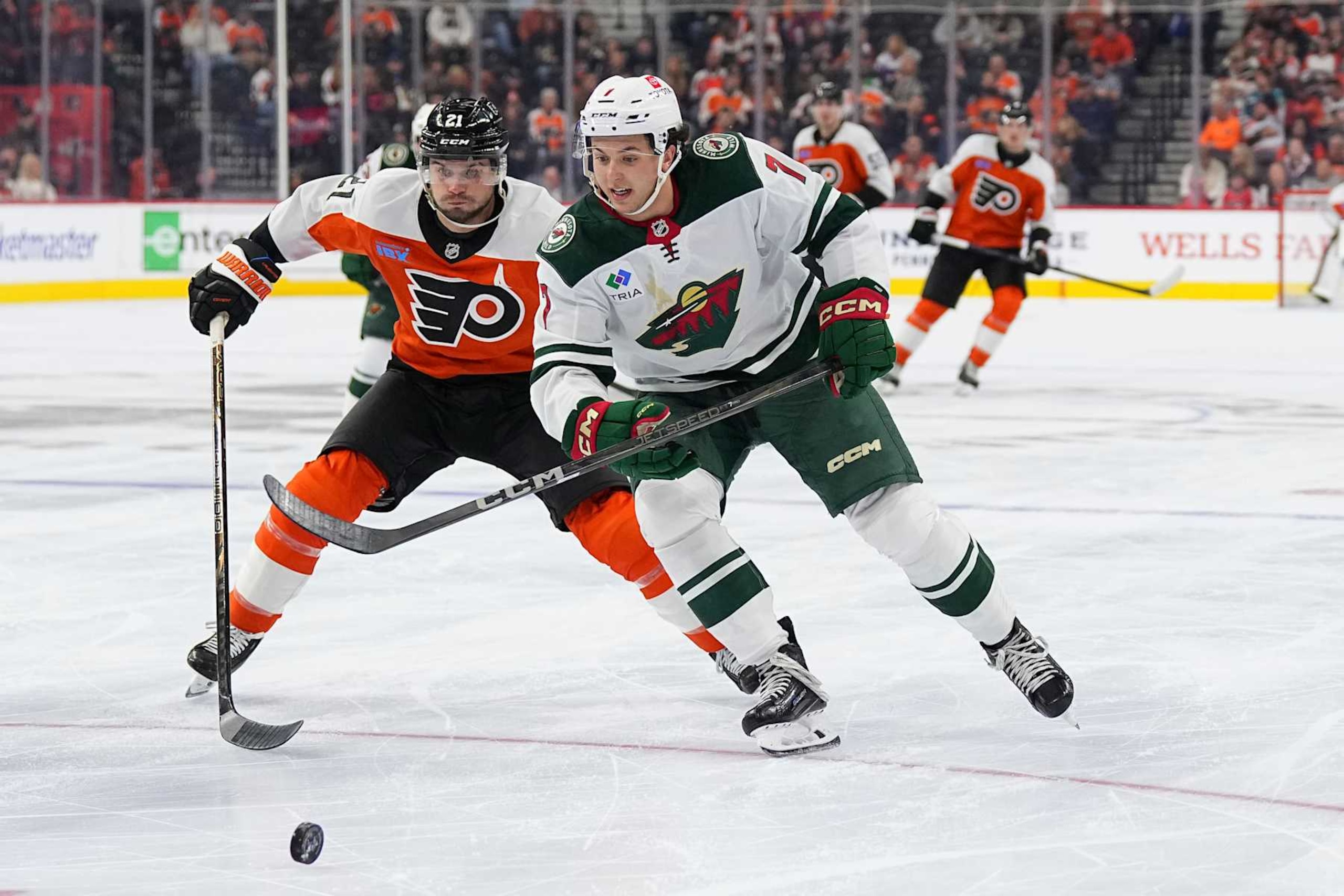 PHILADELPHIA, PENNSYLVANIA - OCTOBER 26: Scott Laughton #21 of the Philadelphia Flyers battles with Brock Faber #7 of the Minnesota Wild at the Wells Fargo Center on October 26, 2024 in Philadelphia, Pennsylvania. The Flyers defeated the Wild 7-5. (Photo by Mitchell Leff/Getty Images)