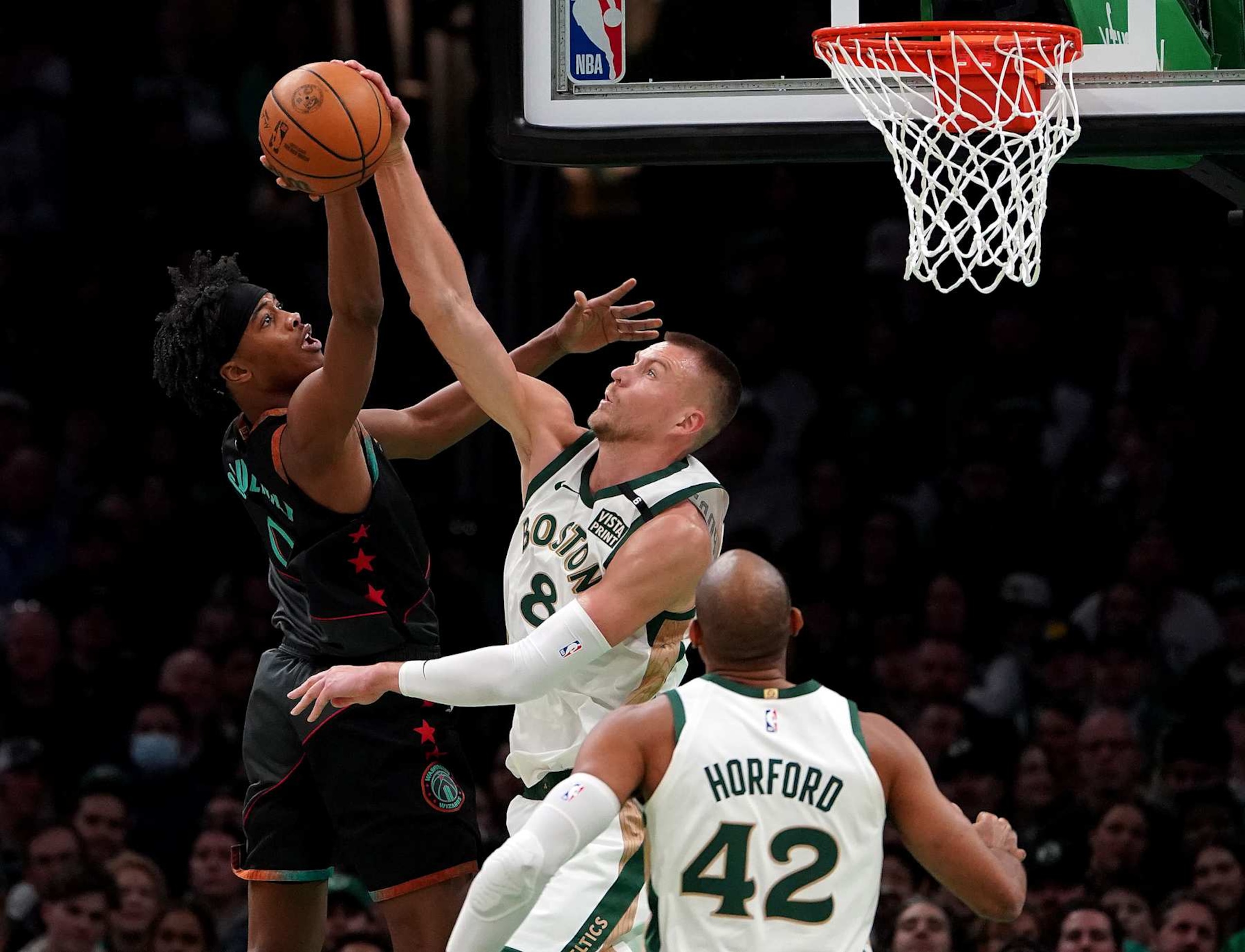 Boston, MA - February 9: Boston Celtics C Kristaps Porzingis blocks the shot of Washington Wizards SF Bilal Coulibaly in the first quarter. The Celtics beat the Wizards, 133-129. (Photo by Barry Chin/The Boston Globe via Getty Images)