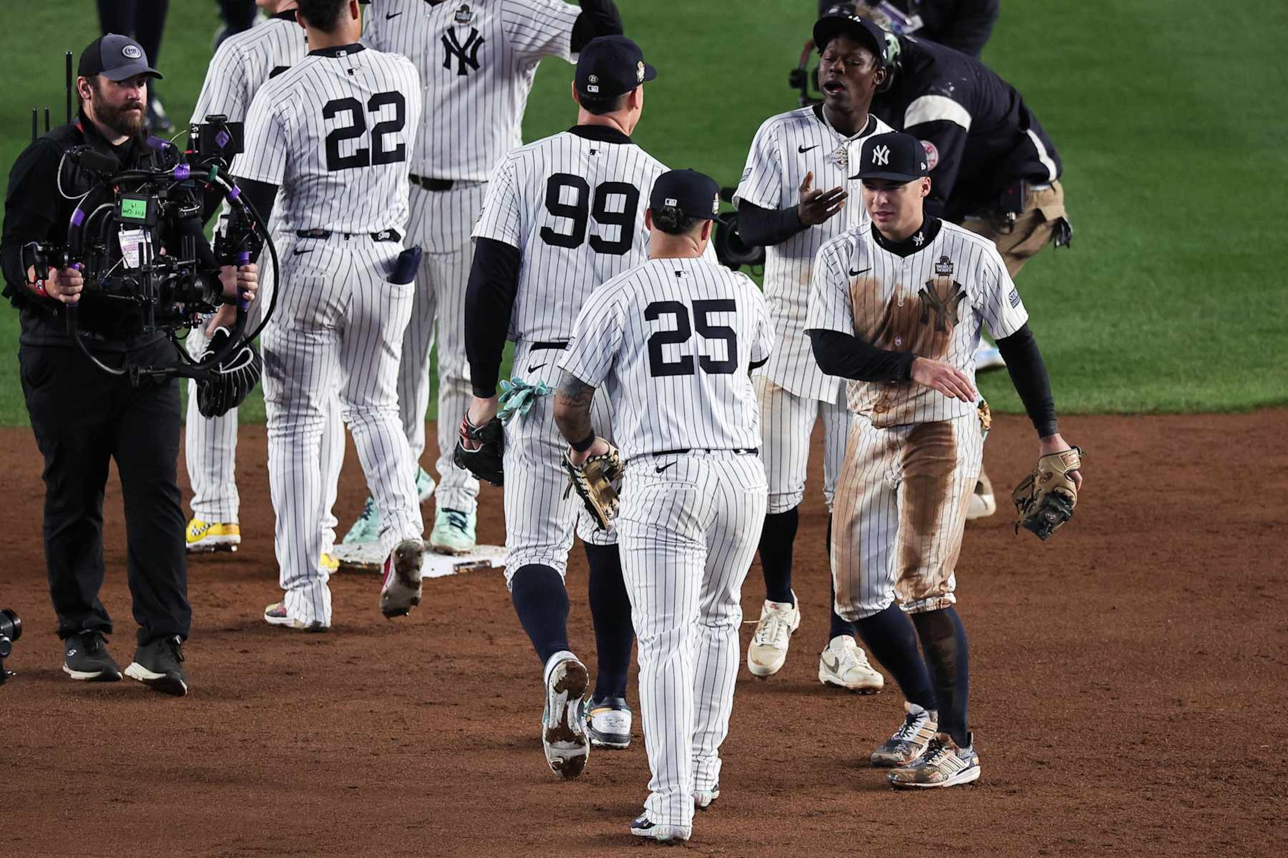 NEW YORK, NY - OCTOBER 29:   Aaron Judge #99 and Gleyber Torres #25 of the New York Yankees celebrate with Jazz Chisholm Jr. #13 and Anthony Volpe #11 after winning Game 4 of the 2024 World Series presented by Capital One between the Los Angeles Dodgers and the New York Yankees at Yankee Stadium on Tuesday, October 29, 2024 in New York, New York. (Photo by Dustin Satloff/MLB Photos via Getty Images)