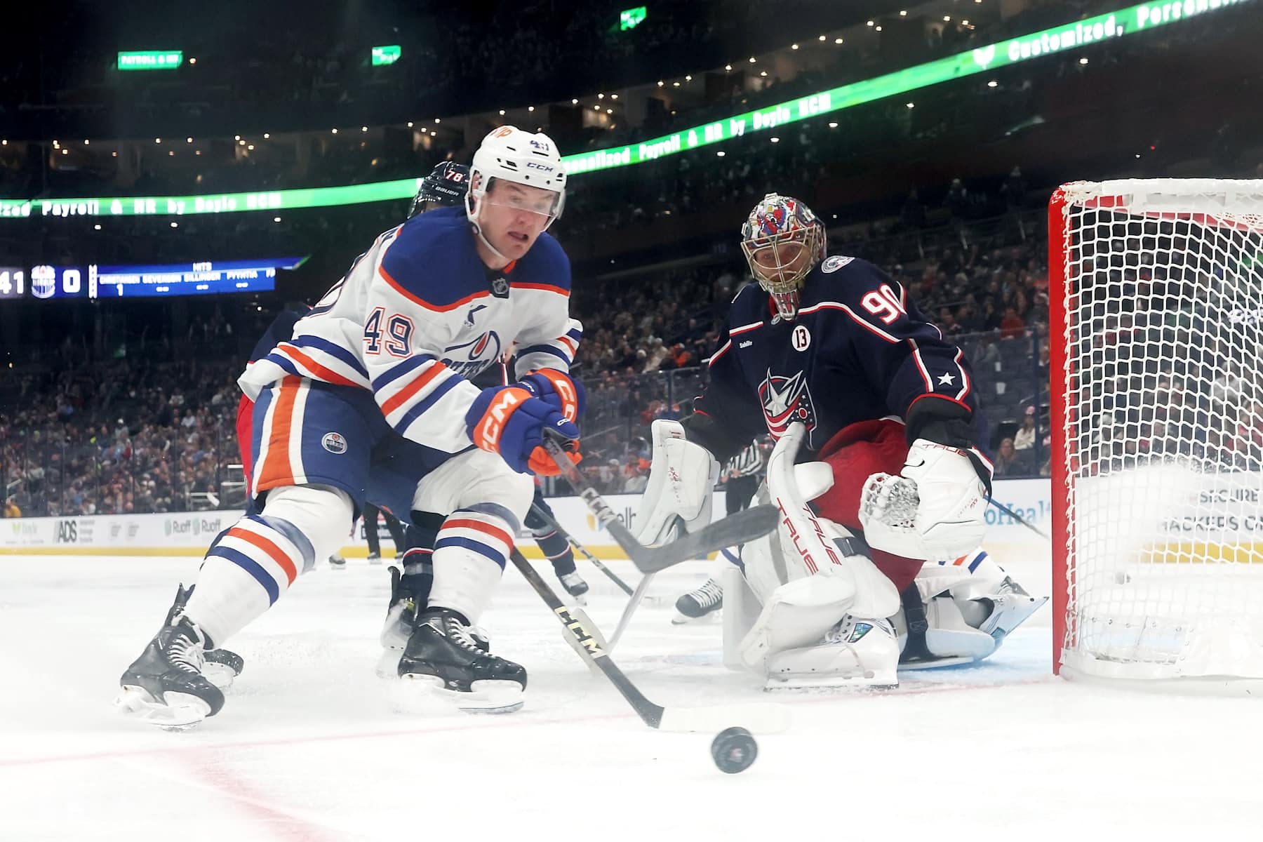COLUMBUS, OHIO - OCTOBER 28:  Ty Emberson #49 of the Edmonton Oilers gathers up the puck as it slides past Elvis Merzlikins #90 of the Columbus Blue Jackets during the third period of the game at Nationwide Arena on October 28, 2024 in Columbus, Ohio. Columbus defeated Edmonton 6-1. (Photo by Kirk Irwin/NHLI via Getty Images)