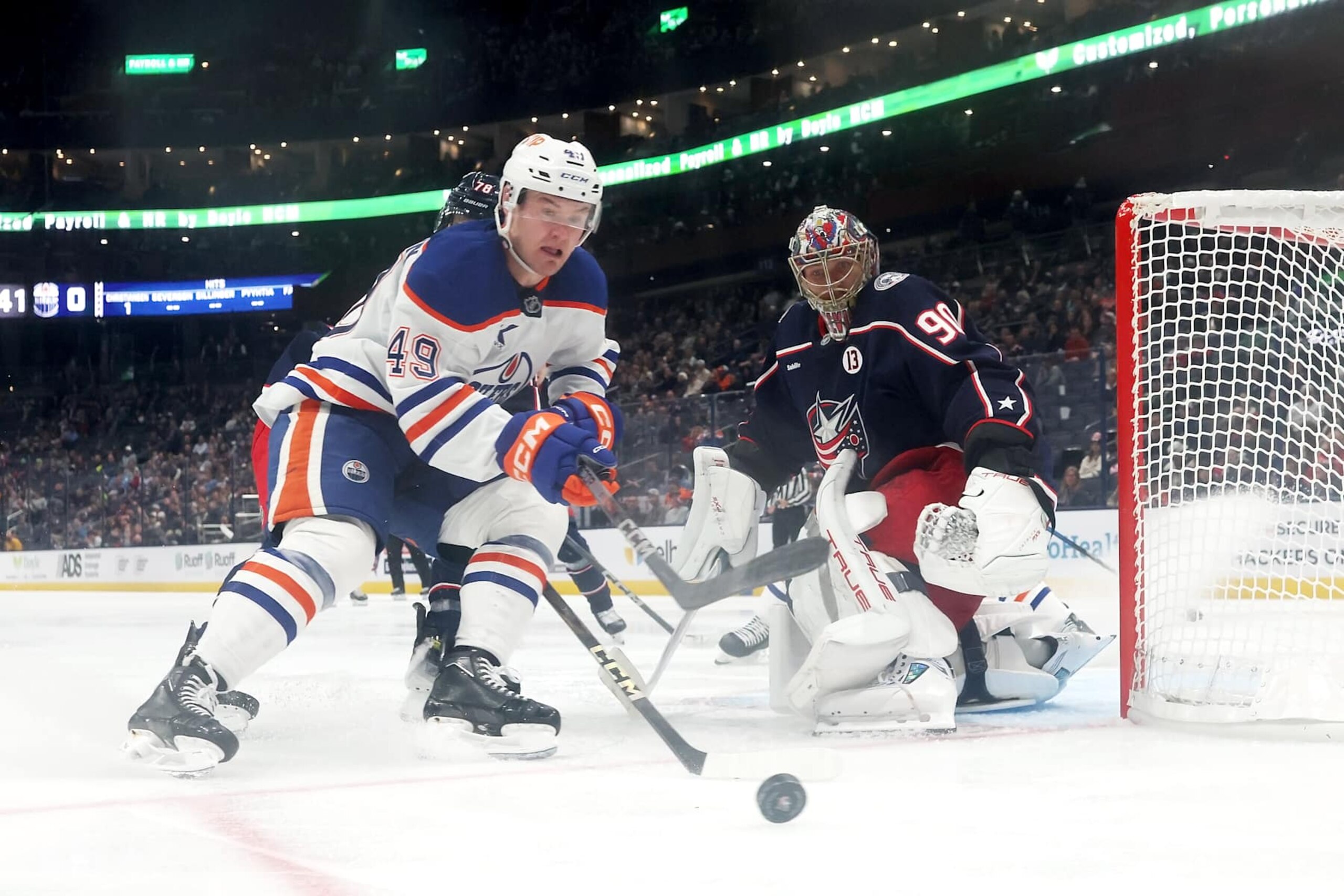 COLUMBUS, OHIO - OCTOBER 28:  Ty Emberson #49 of the Edmonton Oilers gathers up the puck as it slides past Elvis Merzlikins #90 of the Columbus Blue Jackets during the third period of the game at Nationwide Arena on October 28, 2024 in Columbus, Ohio. Columbus defeated Edmonton 6-1. (Photo by Kirk Irwin/NHLI via Getty Images)