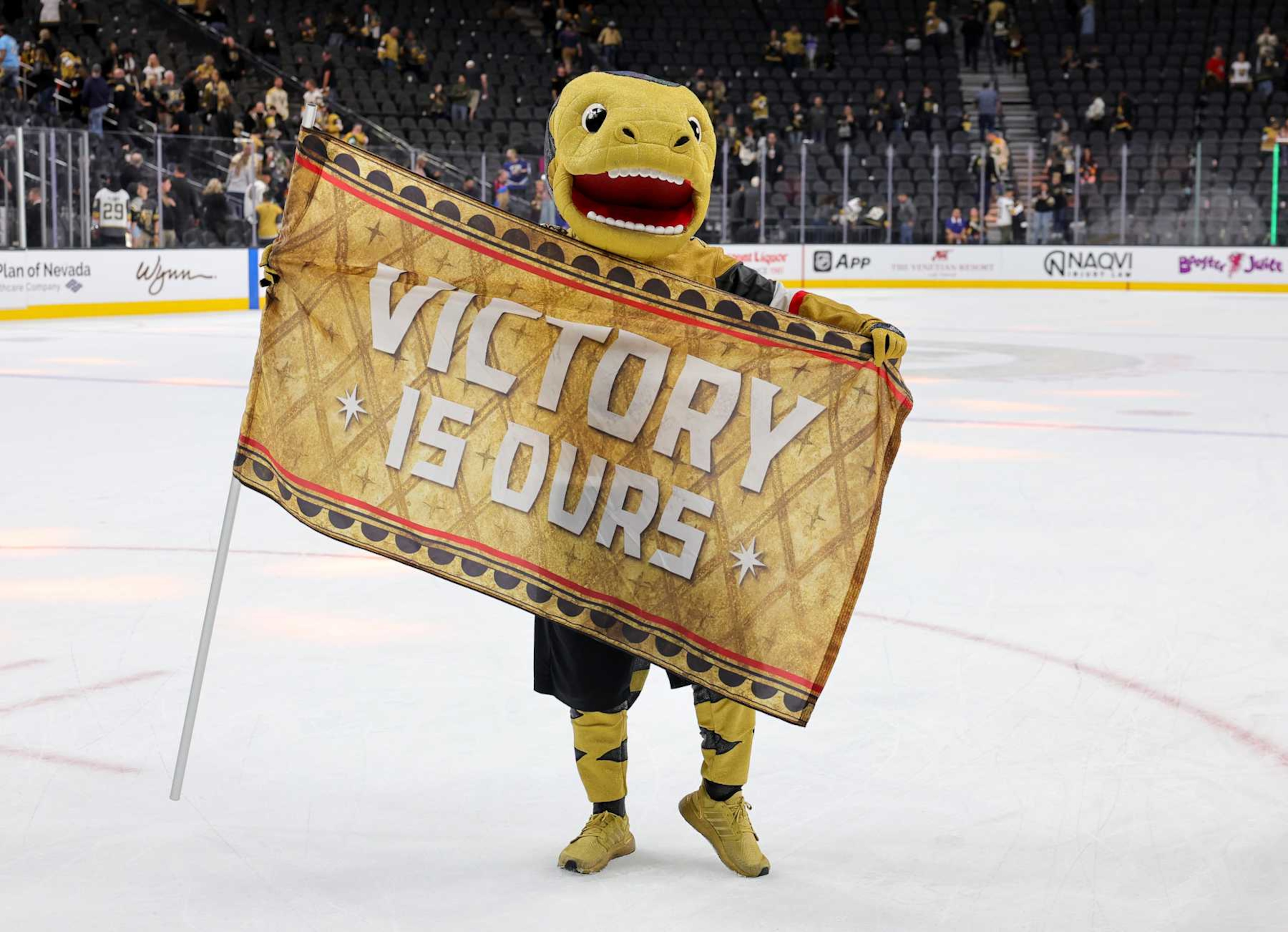 LAS VEGAS, NEVADA - OCTOBER 28: The Vegas Golden Knights mascot Chance the Golden Gila Monster holds a flag with the message "Victory is ours" after the team's 5-0 win over the Calgary Flames at T-Mobile Arena on October 28, 2024 in Las Vegas, Nevada. (Photo by Ethan Miller/Getty Images) LAS VEGAS, NEVADA - OCTOBER 28: The Vegas Golden Knights mascot Chance the Golden Gila Monster holds a flag with the message "Victory is ours" after the team's 5-0 win over the Calgary Flames at T-Mobile Arena on October 28, 2024 in Las Vegas, Nevada. (Photo by Ethan Miller/Getty Images)