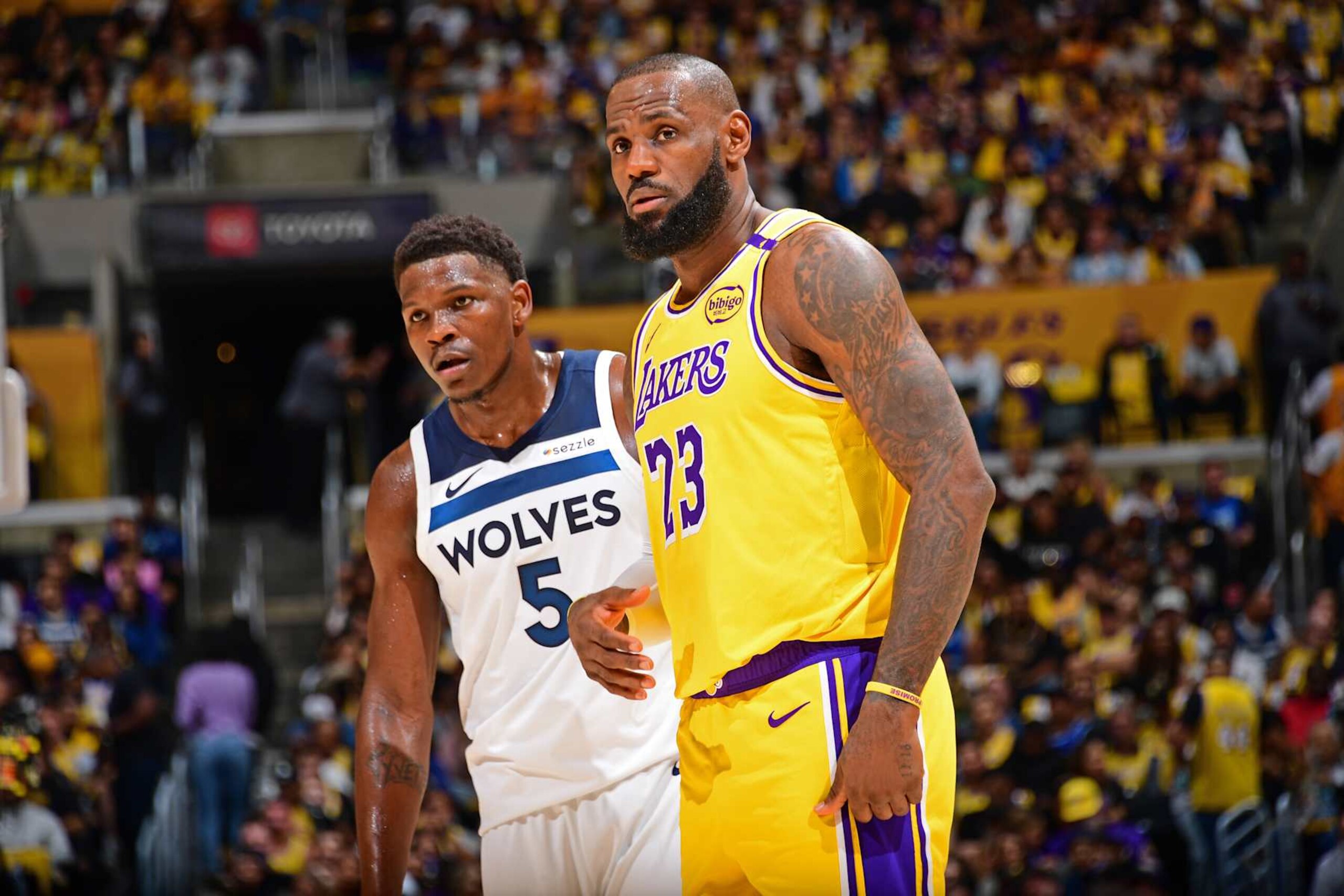 LOS ANGELES, CA - OCTOBER 22: Anthony Edwards #5 of the Minnesota Timberwolves and LeBron James #23 of the Los Angeles Lakers look on during the game on October 22, 2024 at Crypto.Com Arena in Los Angeles, California. NOTE TO USER: User expressly acknowledges and agrees that, by downloading and/or using this Photograph, user is consenting to the terms and conditions of the Getty Images License Agreement. Mandatory Copyright Notice: Copyright 2024 NBAE (Photo by Adam Pantozzi/NBAE via Getty Images)