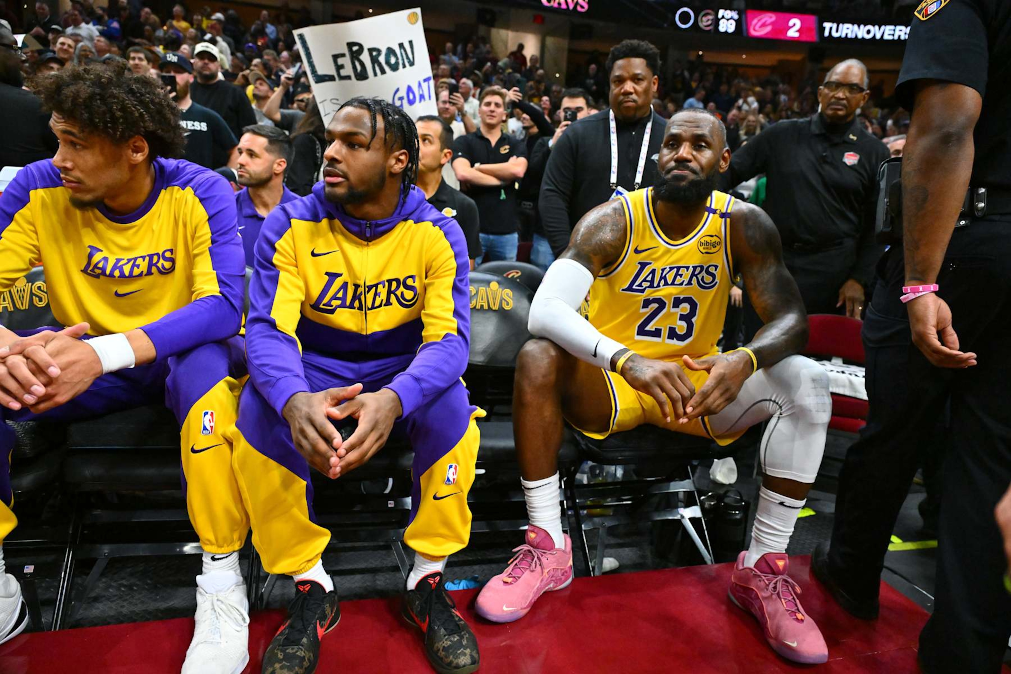 CLEVELAND, OHIO - OCTOBER 30: Bronny James #9 sits with LeBron James #23 of the Los Angeles Lakers on the bench during the first half against the Cleveland Cavaliers at Rocket Mortgage Fieldhouse on October 30, 2024 in Cleveland, Ohio. NOTE TO USER: User expressly acknowledges and agrees that, by downloading and or using this photograph, User is consenting to the terms and conditions of the Getty Images License Agreement. (Photo by Jason Miller/Getty Images)