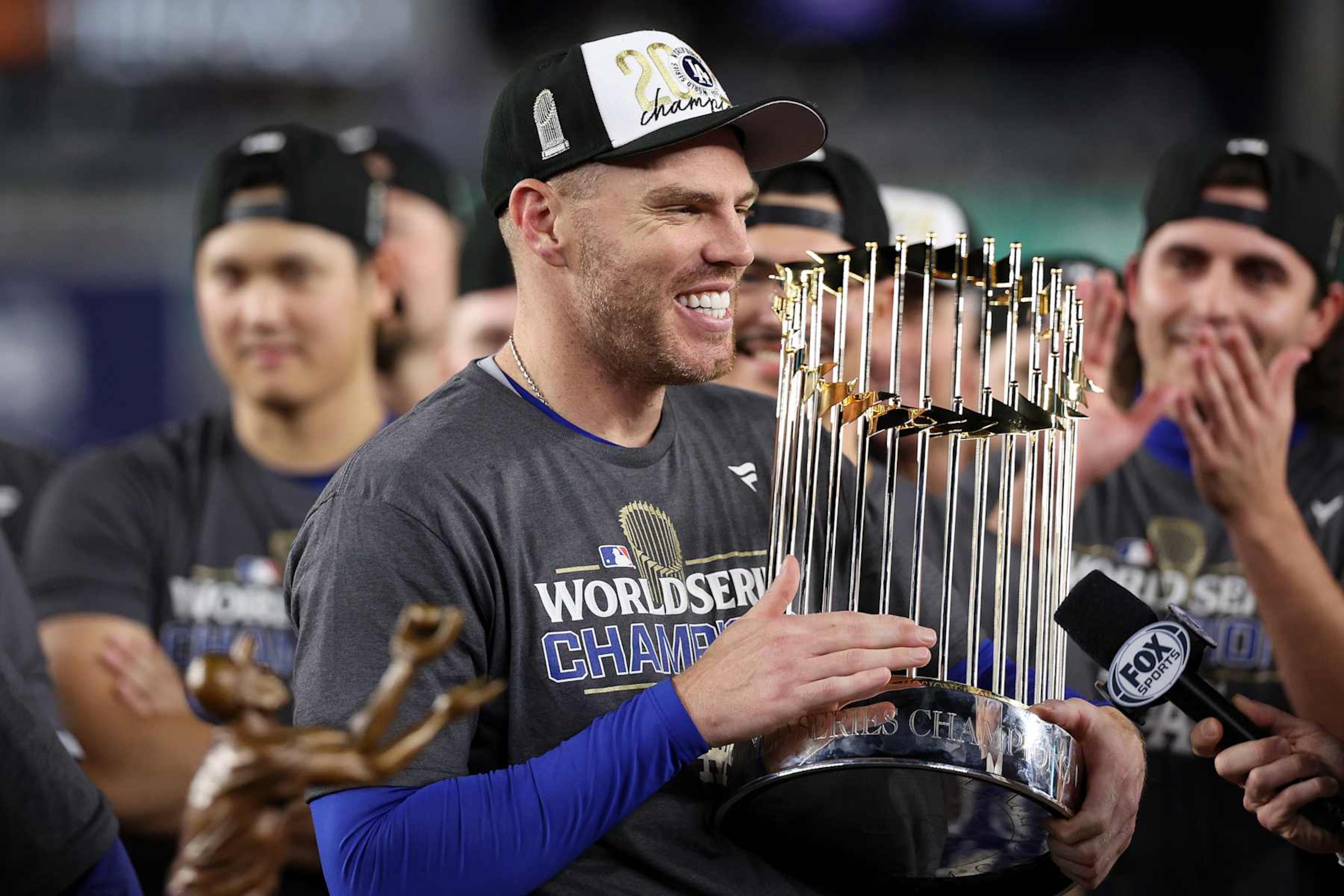 NEW YORK, NEW YORK - OCTOBER 30: Freddie Freeman #5 of the Los Angeles Dodgers celebrates with the trophy after the Dodgers defeated the New York Yankees 7-6 in game 5 to win the 2024 World Series at Yankee Stadium on October 30, 2024 in the Bronx borough of New York City. (Photo by Elsa/Getty Images) NEW YORK, NEW YORK - OCTOBER 30: Freddie Freeman #5 of the Los Angeles Dodgers celebrates with the trophy after the Dodgers defeated the New York Yankees 7-6 in game 5 to win the 2024 World Series at Yankee Stadium on October 30, 2024 in the Bronx borough of New York City. (Photo by Elsa/Getty Images)