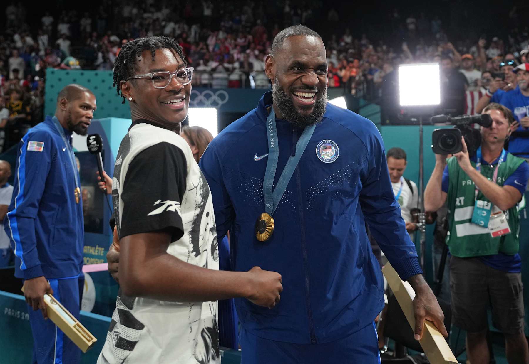 PARIS, FRANCE - AUGUST 10: Bryce James and his father LeBron James celebrates after the Men's Gold Medal Game on August 10, 2024 at the AccorHotels Arena in Paris, France. NOTE TO USER: User expressly acknowledges and agrees that, by downloading and/or using this photograph, user is consenting to the terms and conditions of the Getty Images License Agreement. Mandatory Copyright Notice: Copyright 2024 NBAE (Photo by Jesse D. Garrabrant/NBAE via Getty Images)