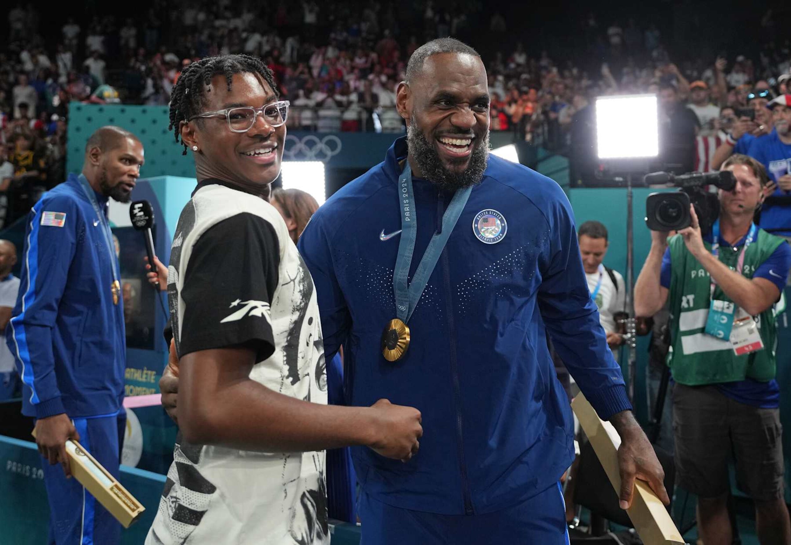 PARIS, FRANCE - AUGUST 10: Bryce James and his father LeBron James celebrates after the Men's Gold Medal Game on August 10, 2024 at the AccorHotels Arena in Paris, France. NOTE TO USER: User expressly acknowledges and agrees that, by downloading and/or using this photograph, user is consenting to the terms and conditions of the Getty Images License Agreement. Mandatory Copyright Notice: Copyright 2024 NBAE (Photo by Jesse D. Garrabrant/NBAE via Getty Images)