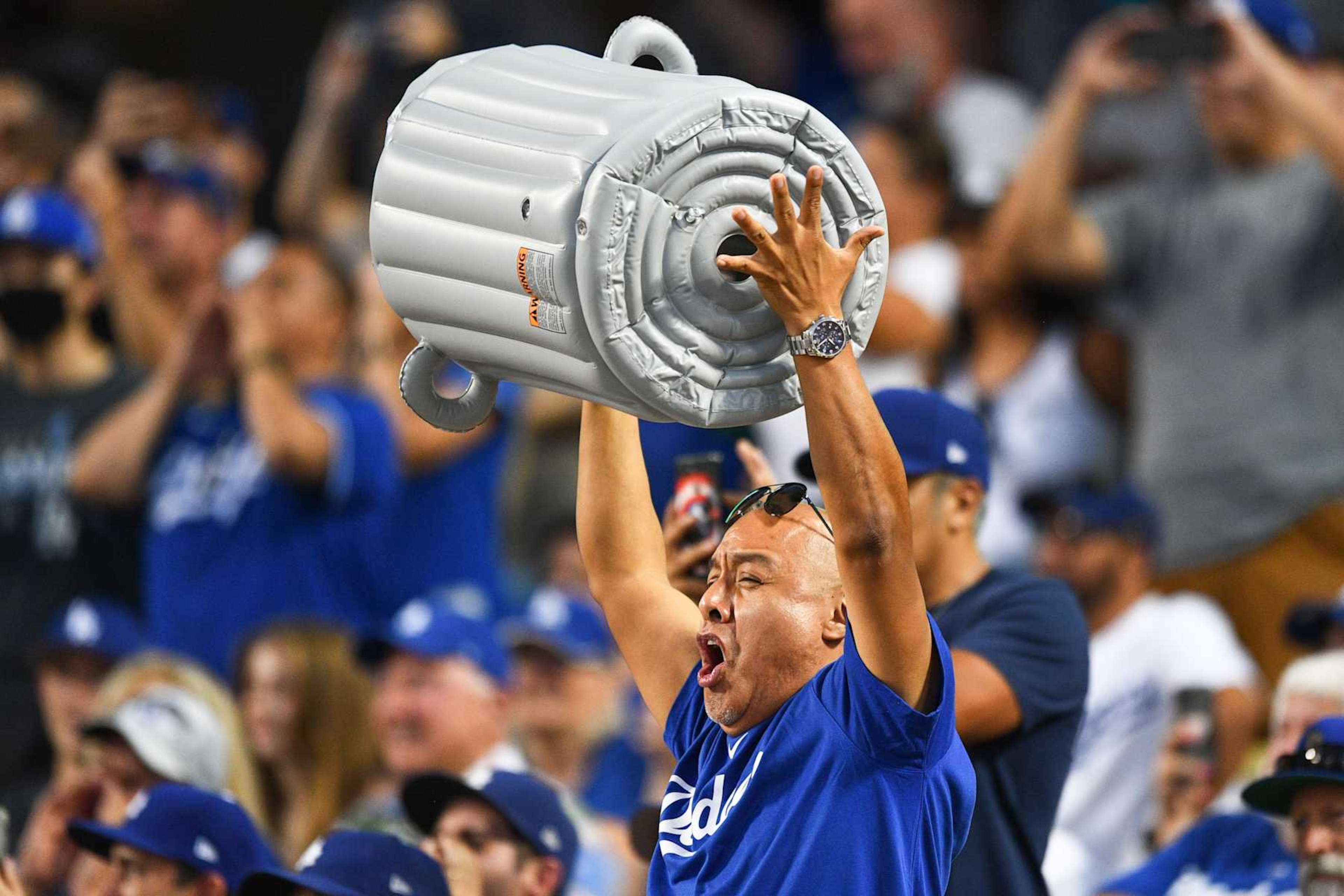 LOS ANGELES, CA - AUGUST 03: A Dodgers fan bangs a blowup trash can during the MLB game between the Houston Astros and the Los Angeles Dodgers on August 3, 2021 at Dodger Stadium in Los Angeles, CA. (Photo by Brian Rothmuller/Icon Sportswire via Getty Images) LOS ANGELES, CA - AUGUST 03: A Dodgers fan bangs a blowup trash can during the MLB game between the Houston Astros and the Los Angeles Dodgers on August 3, 2021 at Dodger Stadium in Los Angeles, CA. (Photo by Brian Rothmuller/Icon Sportswire via Getty Images)