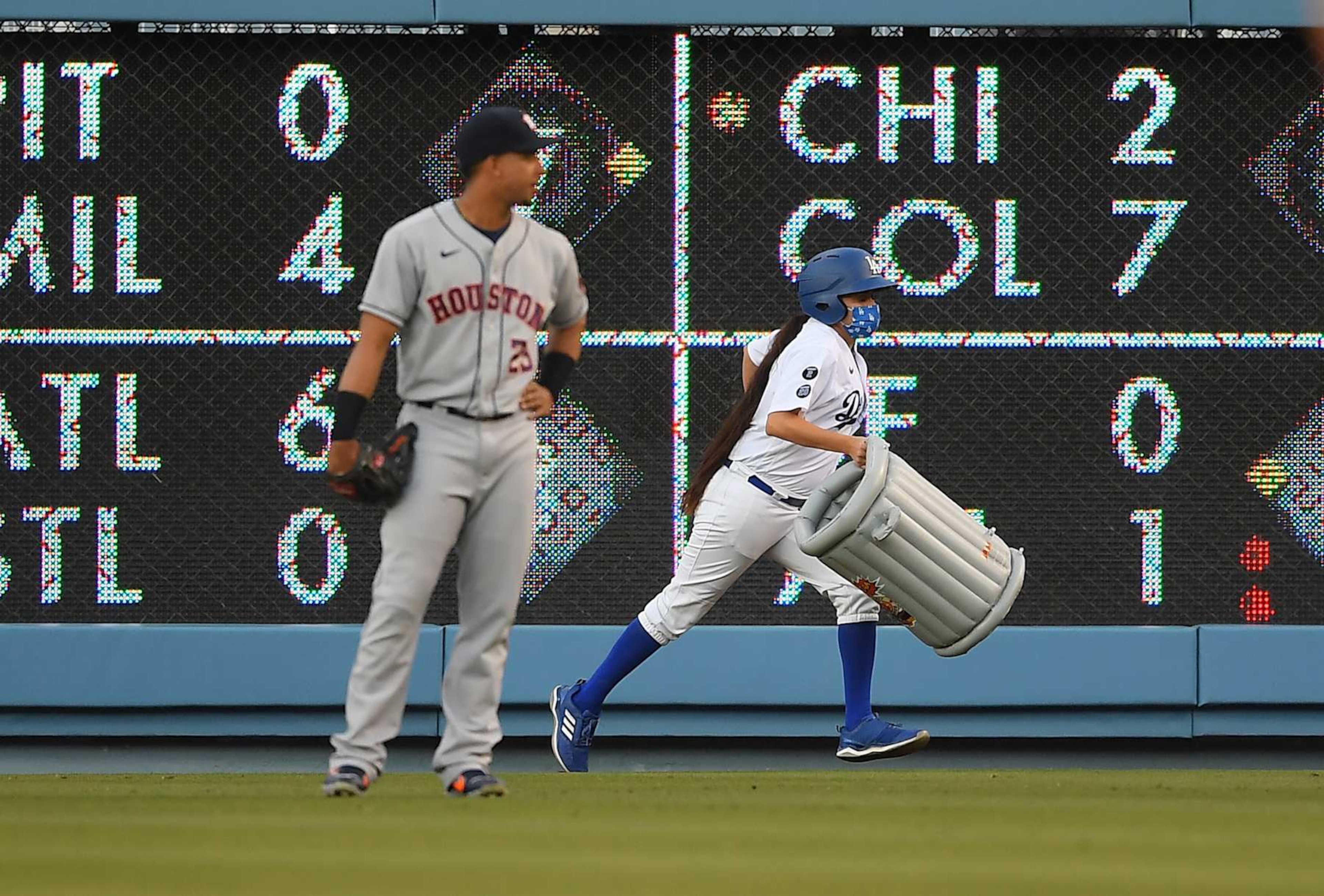 LOS ANGELES, CA - AUGUST 03: Michael Brantley #23 of the Houston Astros watches as a bat girl removes an inflatable trash can that was thrown on to the field in the first inning against the Los Angeles Dodgers at Dodger Stadium on August 3, 2021 in Los Angeles, California. (Photo by Jayne Kamin-Oncea/Getty Images) LOS ANGELES, CA - AUGUST 03: Michael Brantley #23 of the Houston Astros watches as a bat girl removes an inflatable trash can that was thrown on to the field in the first inning against the Los Angeles Dodgers at Dodger Stadium on August 3, 2021 in Los Angeles, California. (Photo by Jayne Kamin-Oncea/Getty Images)