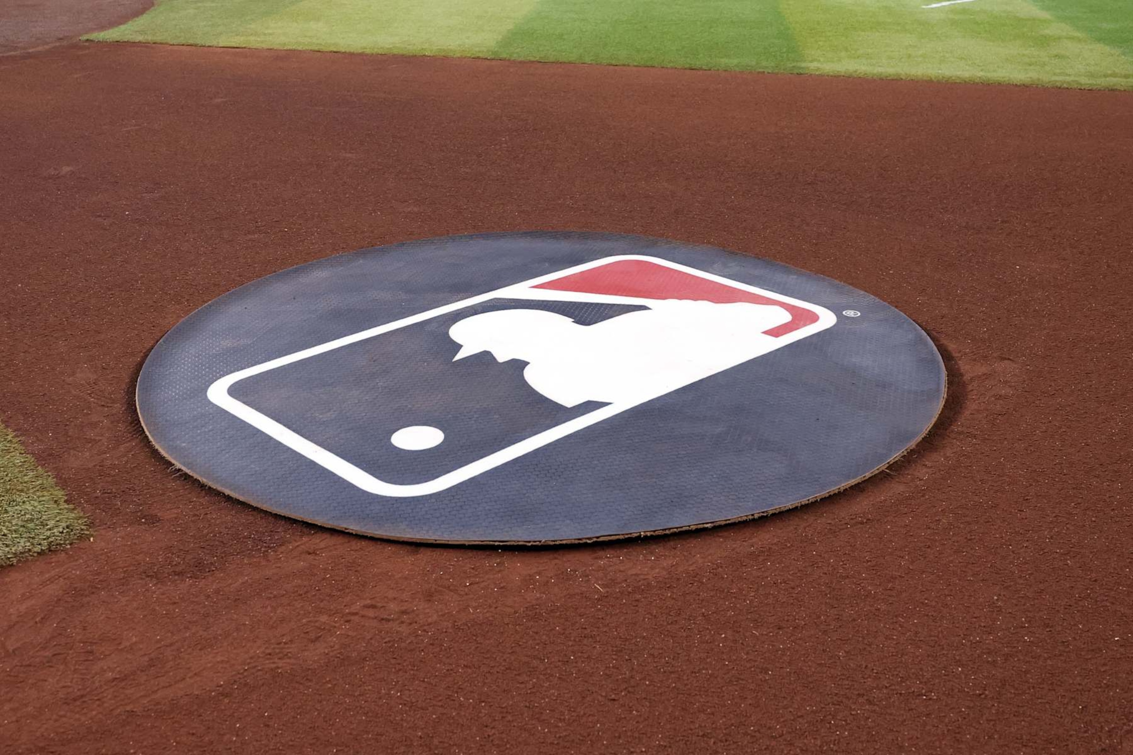 PHOENIX, ARIZONA - SEPTEMBER 10: The MLB logo is seen in the visitor's on deck circle during the game between the Arizona Diamondbacks and the Texas Rangers at Chase Field on September 10, 2024 in Phoenix, Arizona. The Diamondbacks defeated the Rangers 6-0. (Photo by Chris Coduto/Getty Images) PHOENIX, ARIZONA - SEPTEMBER 10: The MLB logo is seen in the visitor's on deck circle during the game between the Arizona Diamondbacks and the Texas Rangers at Chase Field on September 10, 2024 in Phoenix, Arizona. The Diamondbacks defeated the Rangers 6-0. (Photo by Chris Coduto/Getty Images)