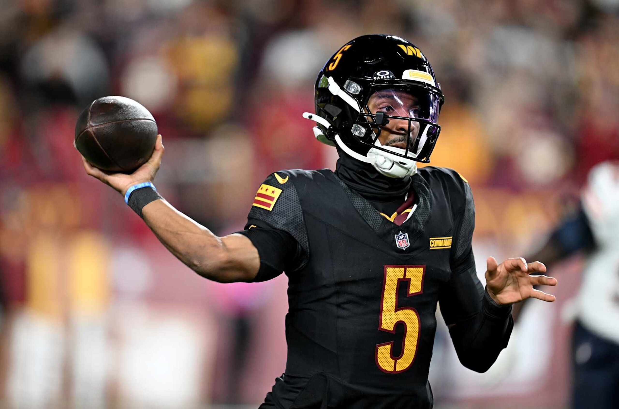 LANDOVER, MARYLAND - OCTOBER 27: Jayden Daniels #5 of the Washington Commanders throws a pass against the Chicago Bears at Northwest Stadium on October 27, 2024 in Landover, Maryland. (Photo by G Fiume/Getty Images)